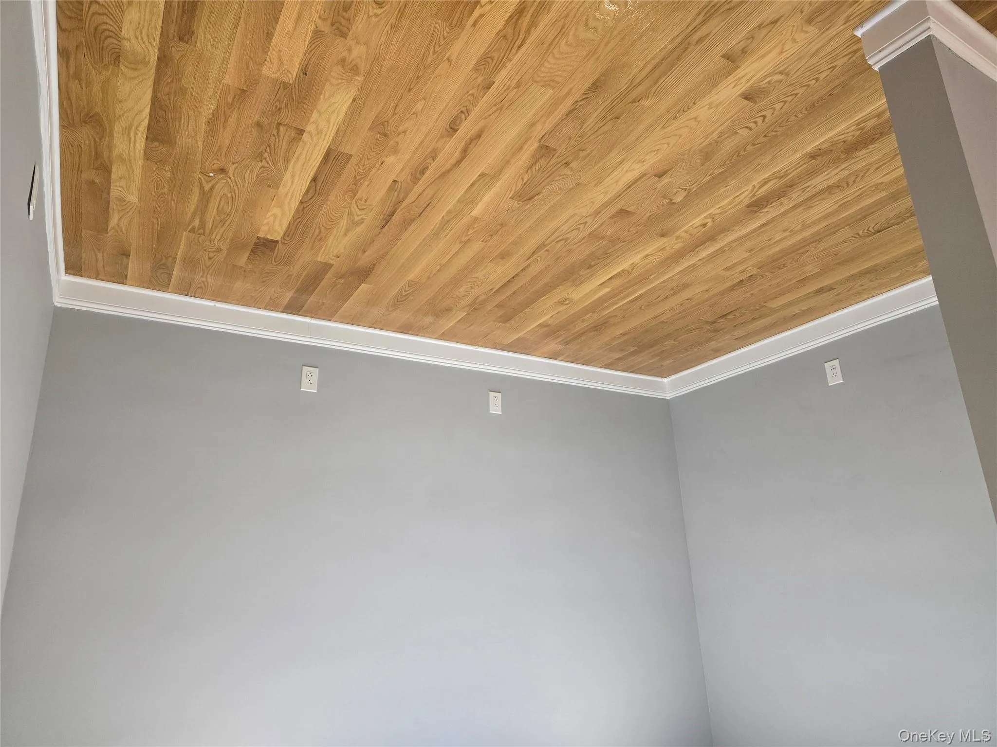 Unfurnished room with baseboards and light wood-style floors Unfurnished room with baseboards and light wood-style floors