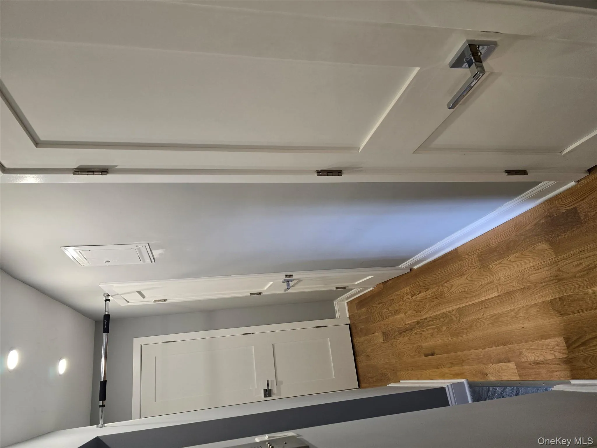 Hallway featuring wood finished floors and recessed lighting Hallway featuring wood finished floors and recessed lighting