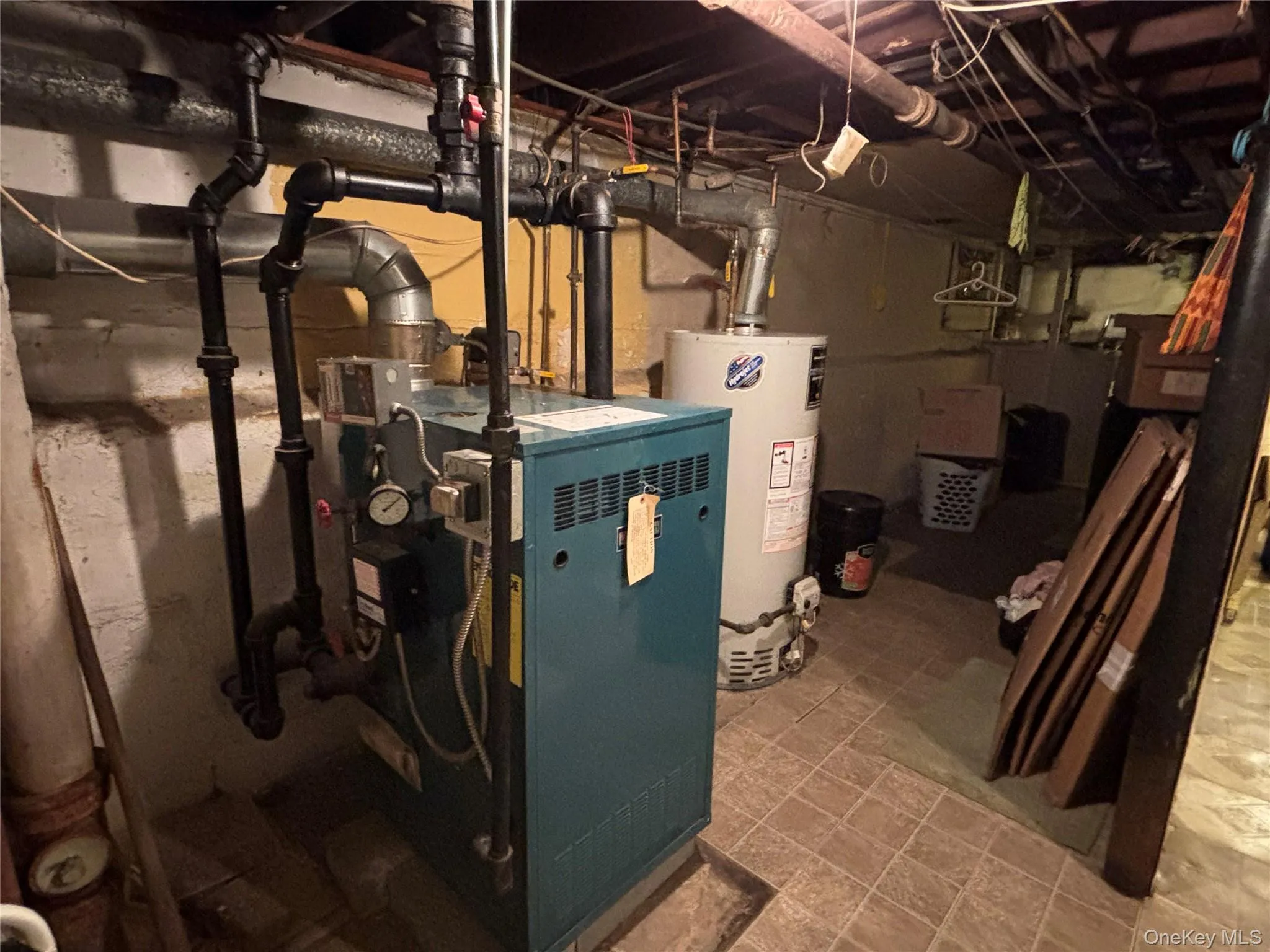 Utilities featuring water heater and a heating unit Utilities featuring water heater and a heating unit