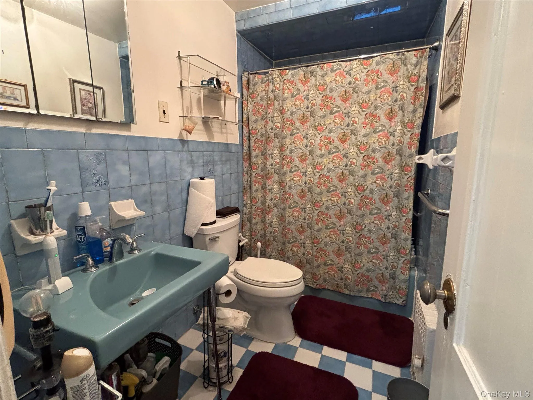 Bathroom featuring tile walls and tile patterned floors Bathroom featuring tile walls and tile patterned floors