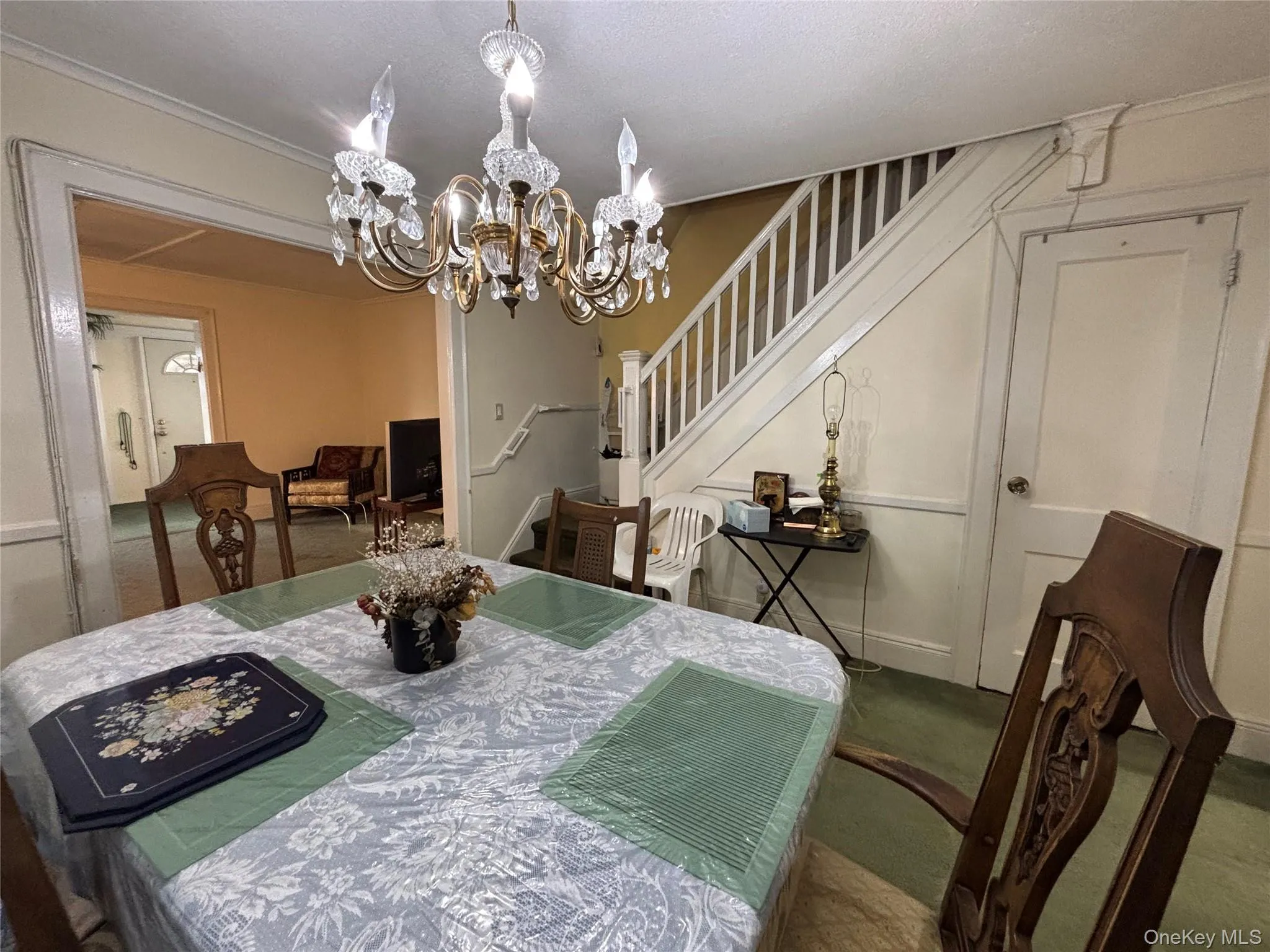 Dining area featuring stairway and a chandelier Dining area featuring stairway and a chandelier