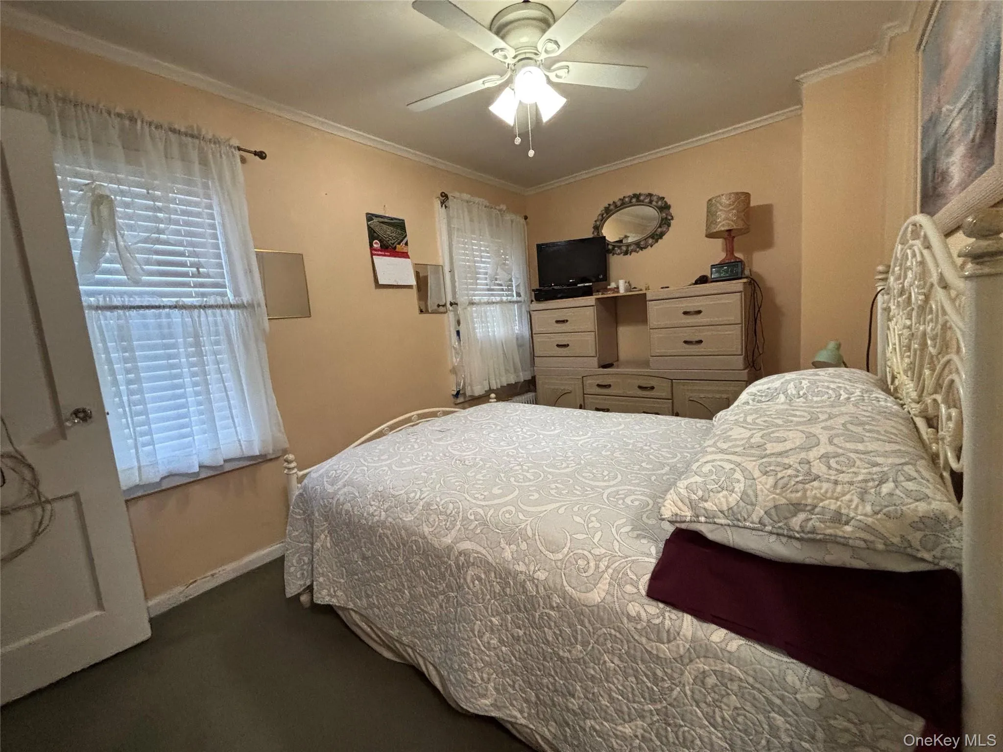 Bedroom with ornamental molding and ceiling fan Bedroom with ornamental molding and ceiling fan