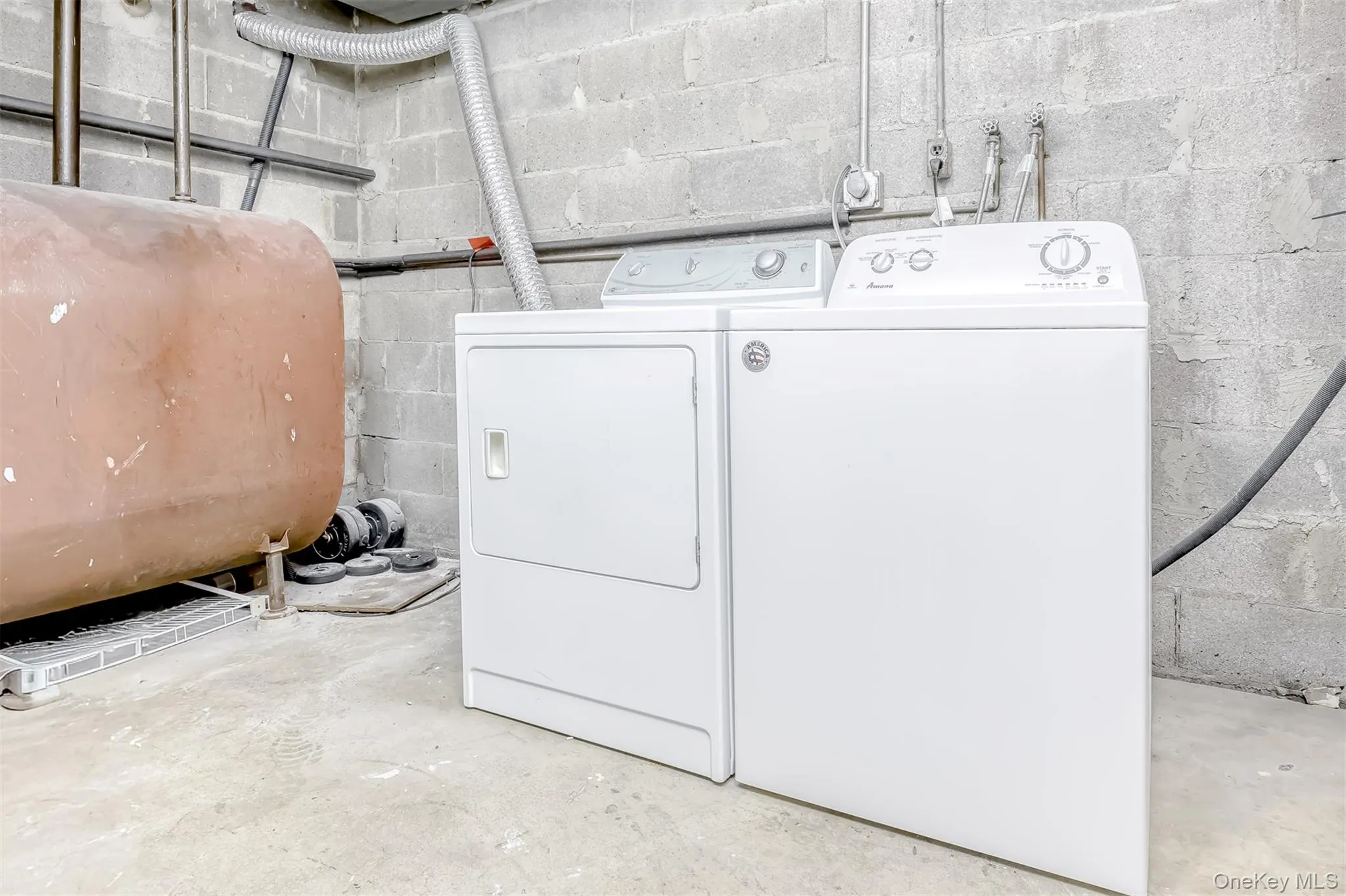 Laundry area with heating fuel, washing machine and dryer in Basement Laundry area with heating fuel, washing machine and dryer in Basement