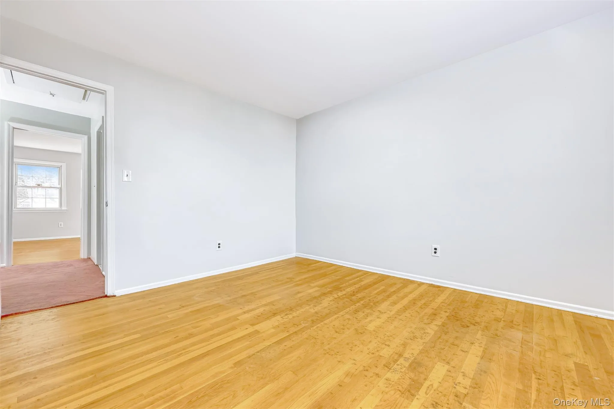 Empty room with wood finished floors and baseboards Empty room with wood finished floors and baseboards
