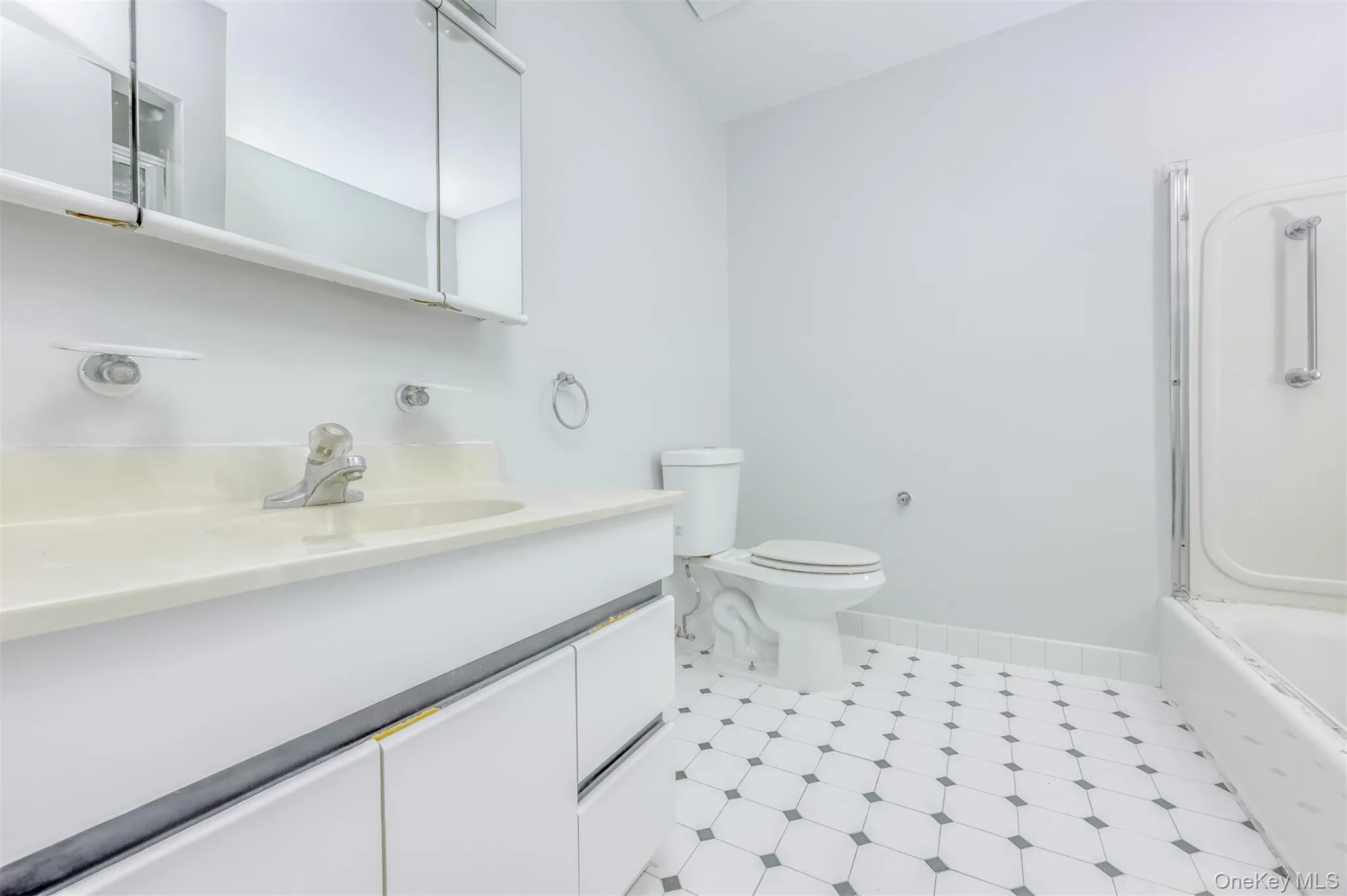 Bathroom featuring vanity, light flooring, and bathing tub / shower combination Bathroom featuring vanity, light flooring, and bathing tub / shower combination