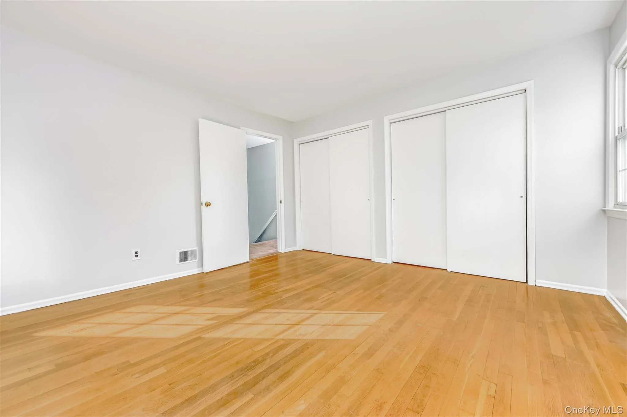Main bedroom with hardwood floors and 2 double closets Main bedroom with hardwood floors and 2 double closets