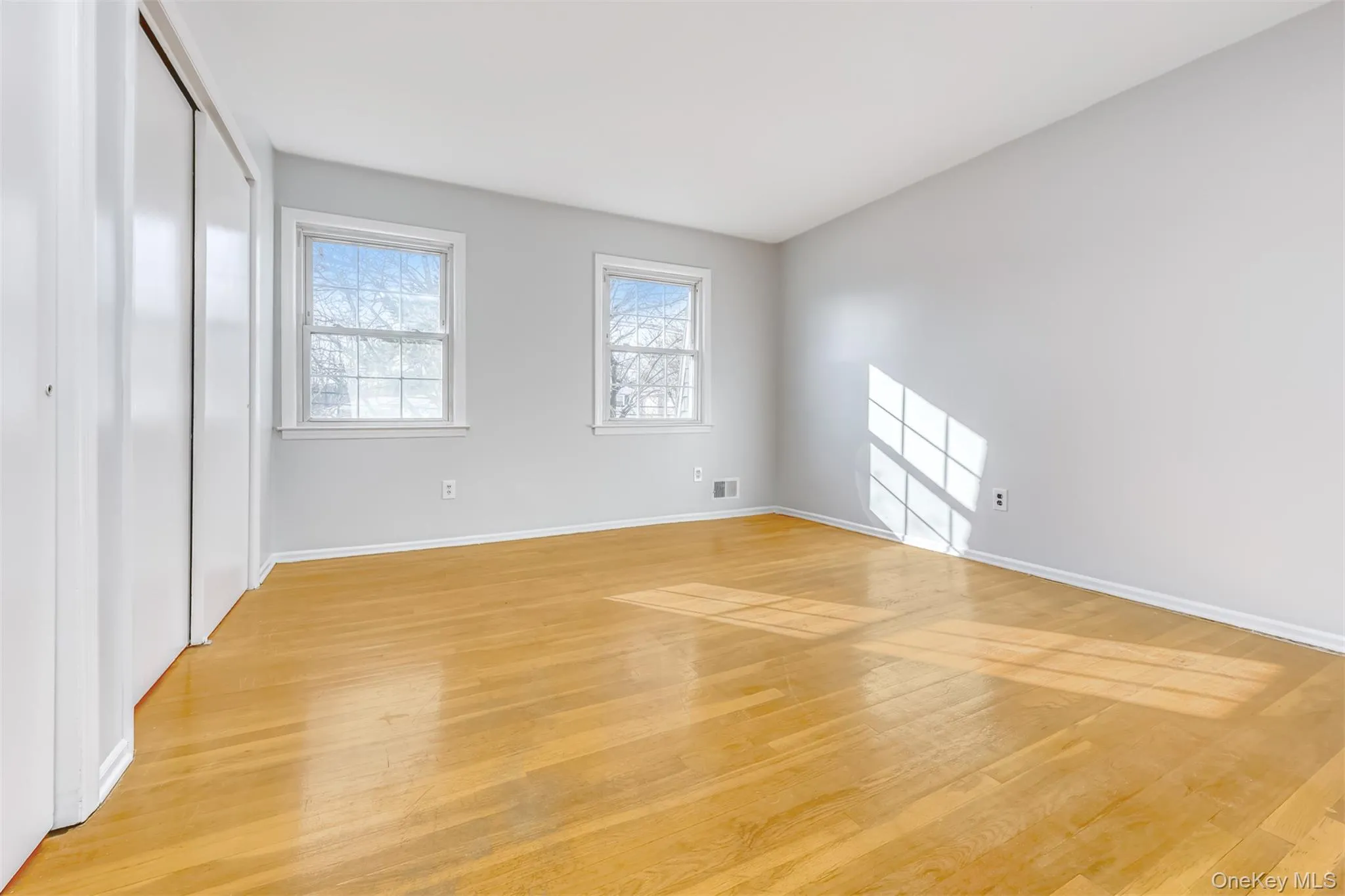 Main bedroom with hardwood floors and 2 double closets Main bedroom with hardwood floors and 2 double closets