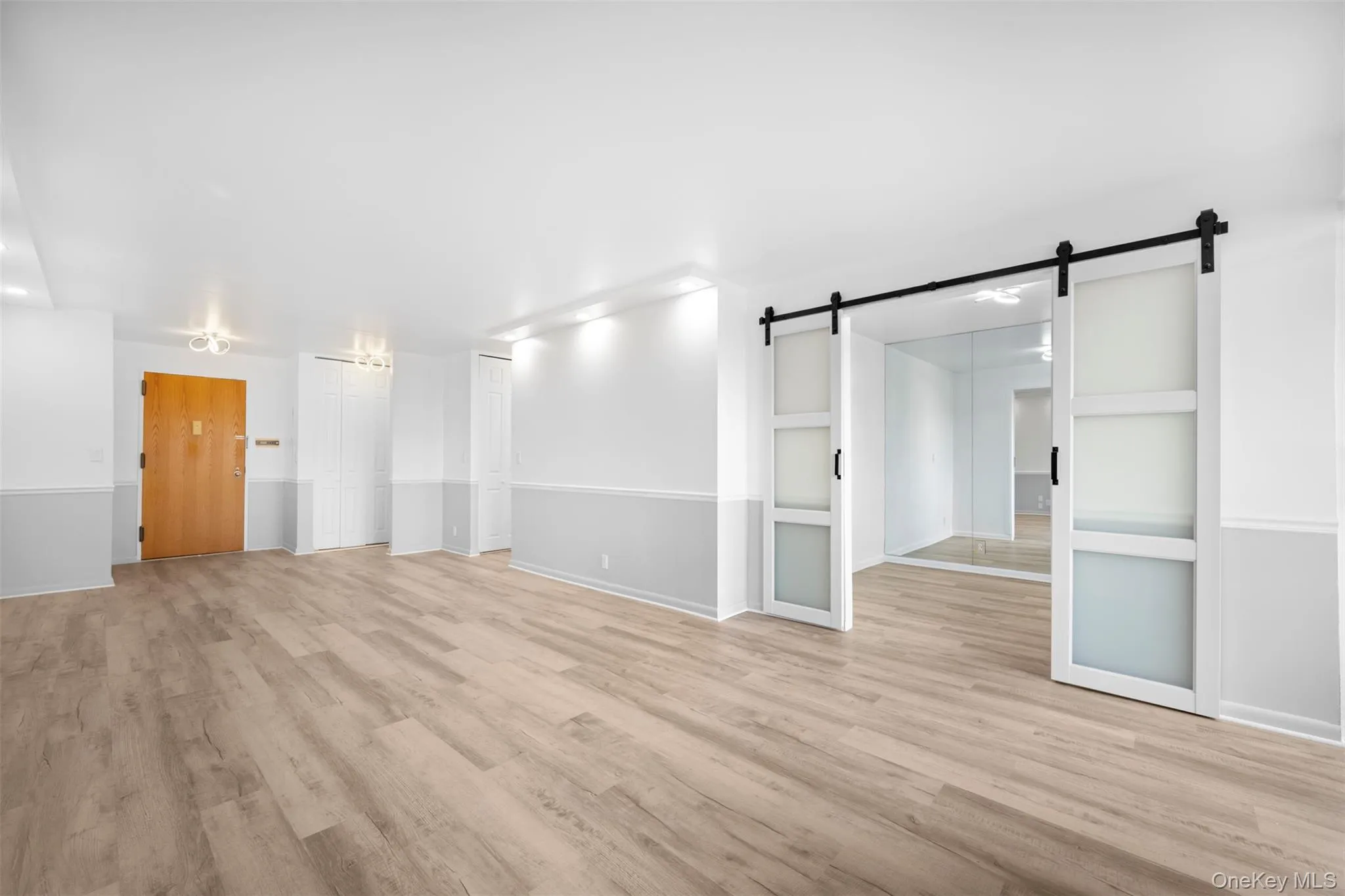 Living Room/ Dining Room with Doors to Bedroom Living Room/ Dining Room with Doors to Bedroom