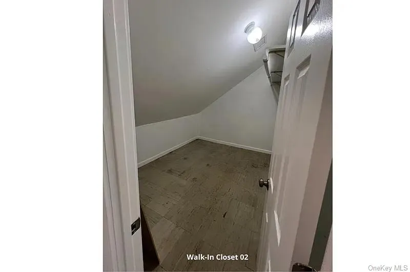 Walk in closet with lofted ceiling Walk in closet with lofted ceiling