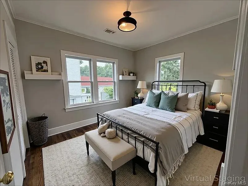 Bedroom with dark wood-style floors and crown molding Bedroom with dark wood-style floors and crown molding