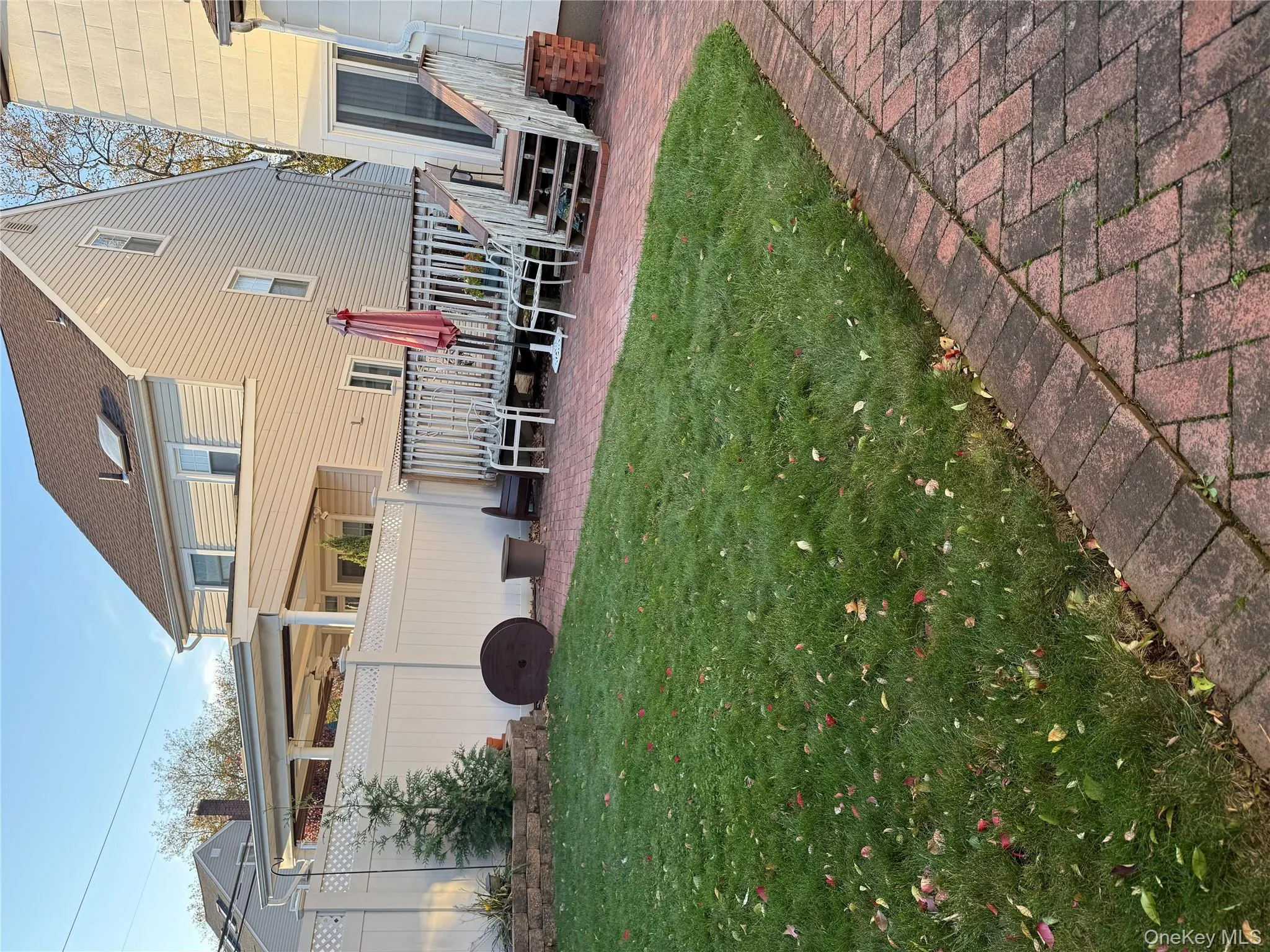Rear view of house featuring a patio area and a wooden deck Rear view of house featuring a patio area and a wooden deck