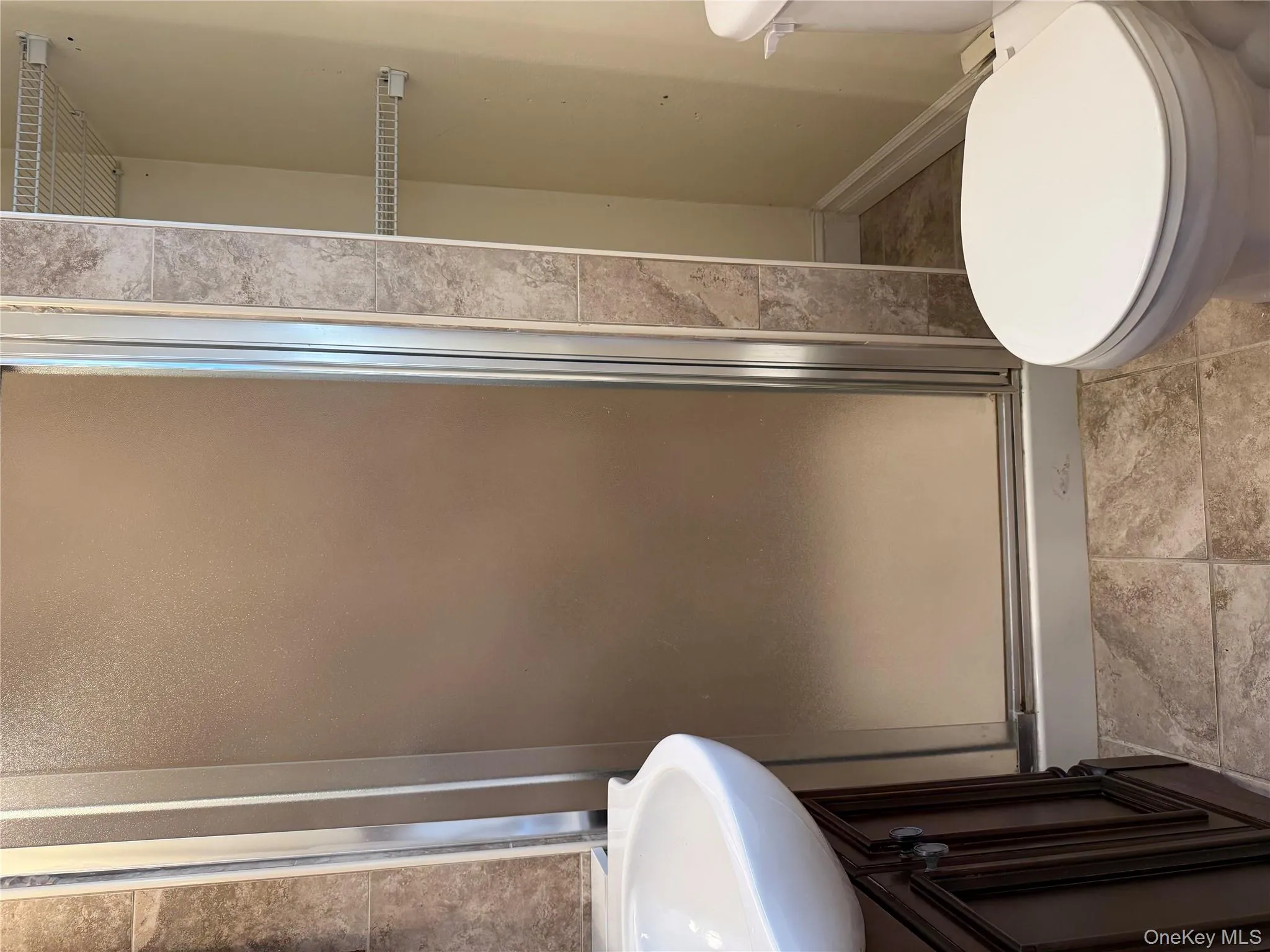 Bathroom featuring vanity, a stall shower, and light tile patterned floors Bathroom featuring vanity, a stall shower, and light tile patterned floors