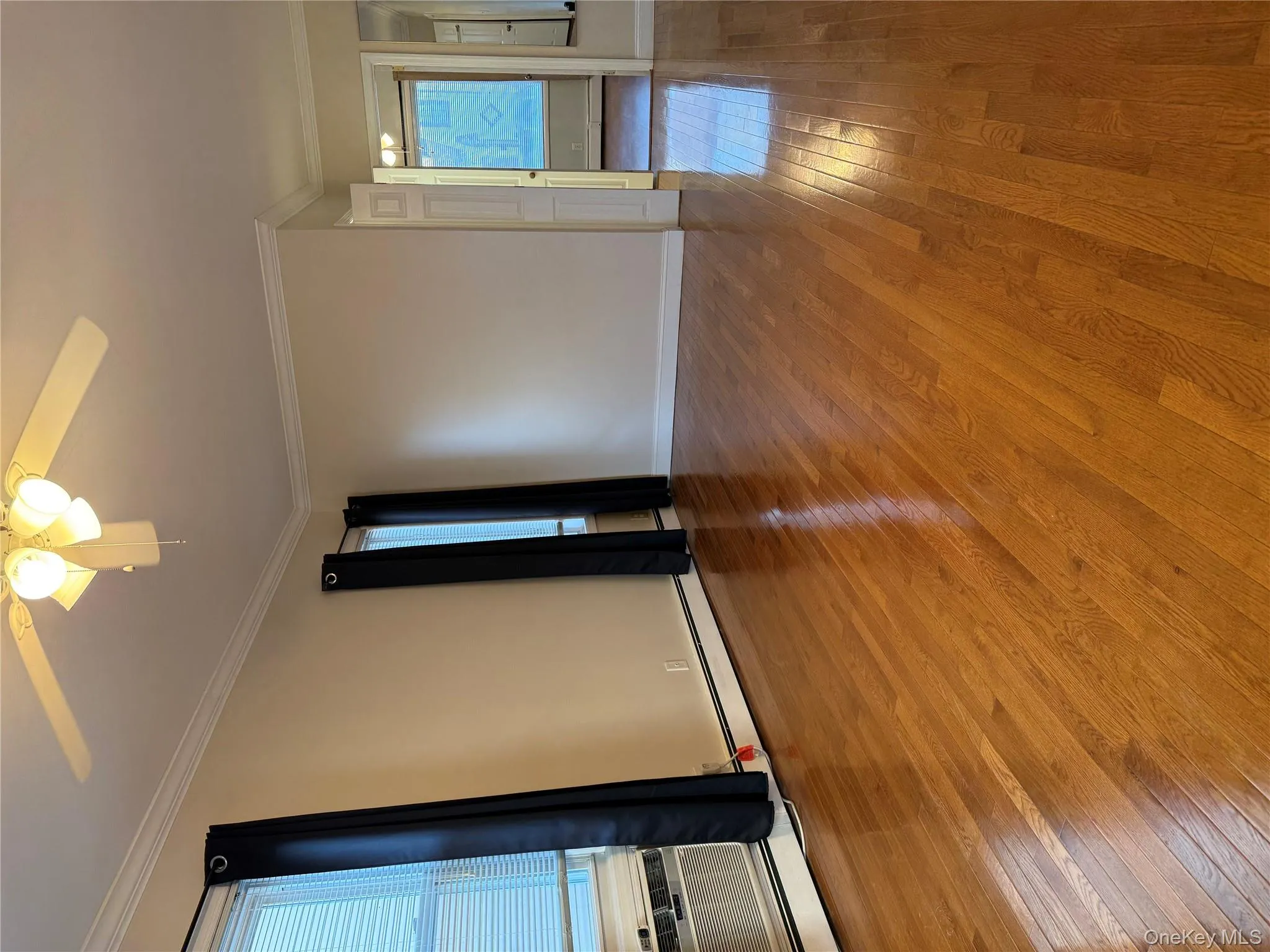 Unfurnished room featuring light wood-style flooring, a baseboard radiator, crown molding, and a ceiling fan Unfurnished room featuring light wood-style flooring, a baseboard radiator, crown molding, and a ceiling fan