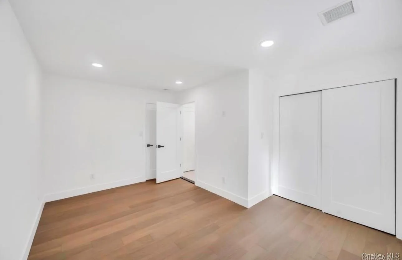 Unfurnished bedroom with recessed lighting, light wood-style floors, and a closet Unfurnished bedroom with recessed lighting, light wood-style floors, and a closet