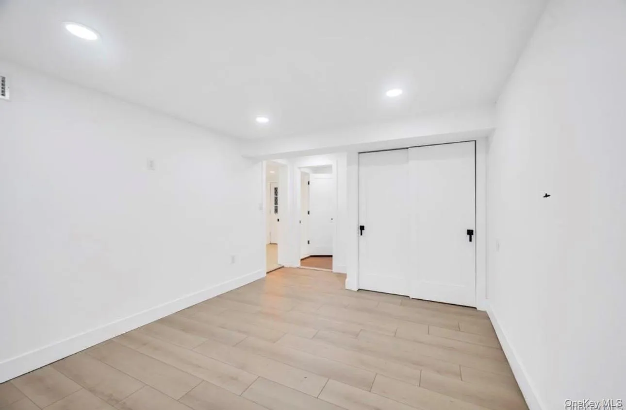 Unfurnished bedroom with light wood-style flooring, a closet, and recessed lighting Unfurnished bedroom with light wood-style flooring, a closet, and recessed lighting