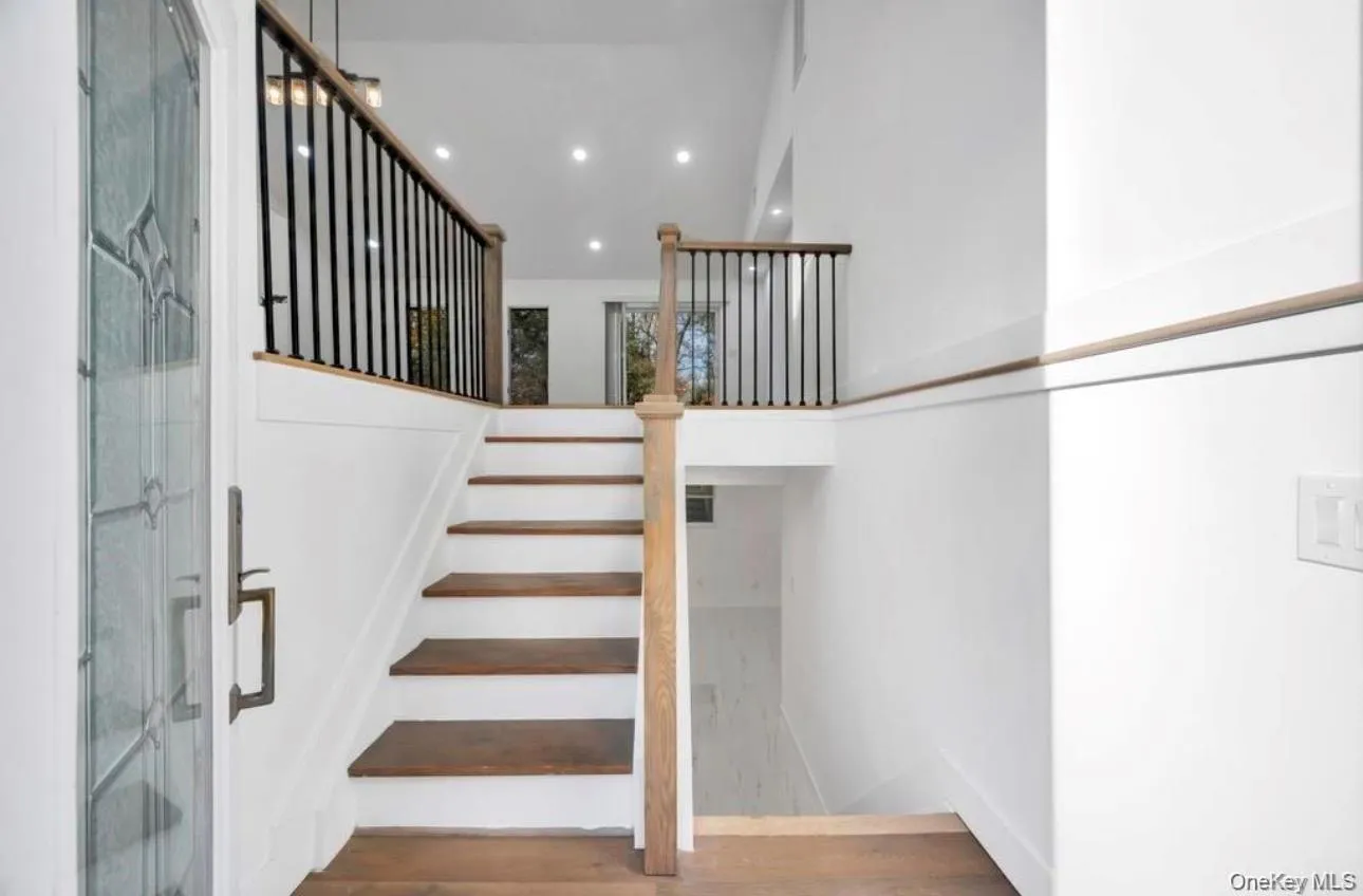 Stairs featuring recessed lighting and wood finished floors Stairs featuring recessed lighting and wood finished floors