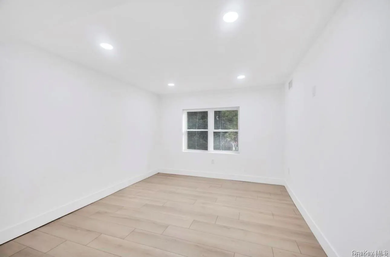 Unfurnished room featuring light wood finished floors and recessed lighting Unfurnished room featuring light wood finished floors and recessed lighting