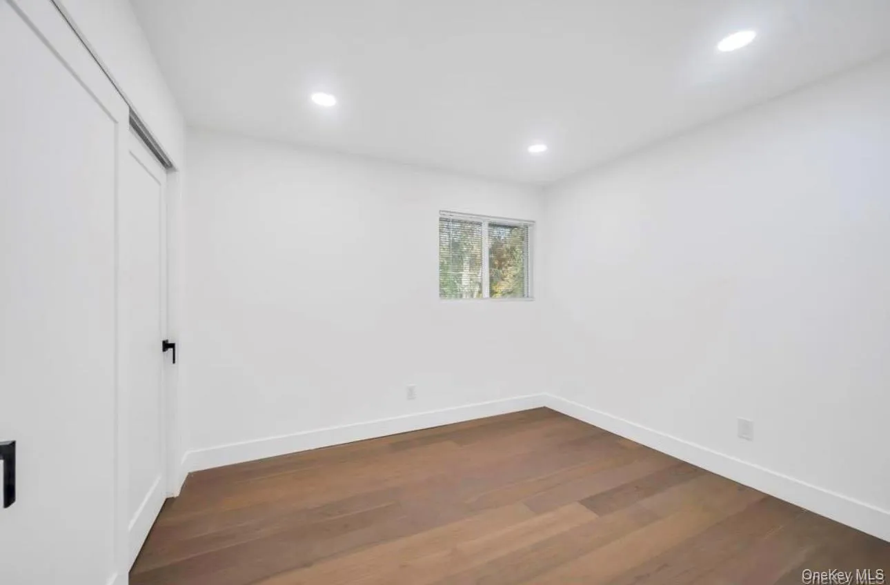 Unfurnished bedroom featuring dark wood-style floors, a closet, and recessed lighting Unfurnished bedroom featuring dark wood-style floors, a closet, and recessed lighting