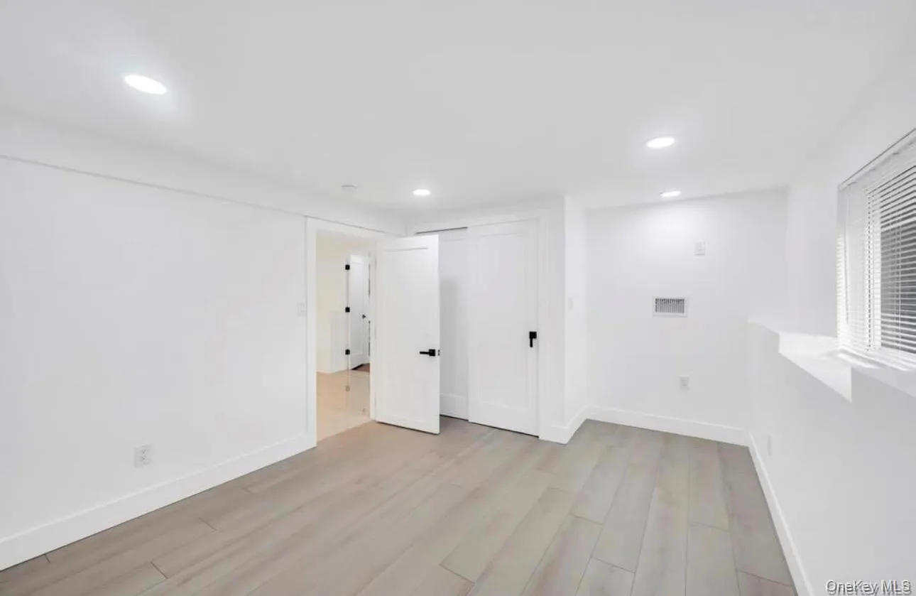 Below grade area featuring light wood finished floors and recessed lighting Below grade area featuring light wood finished floors and recessed lighting