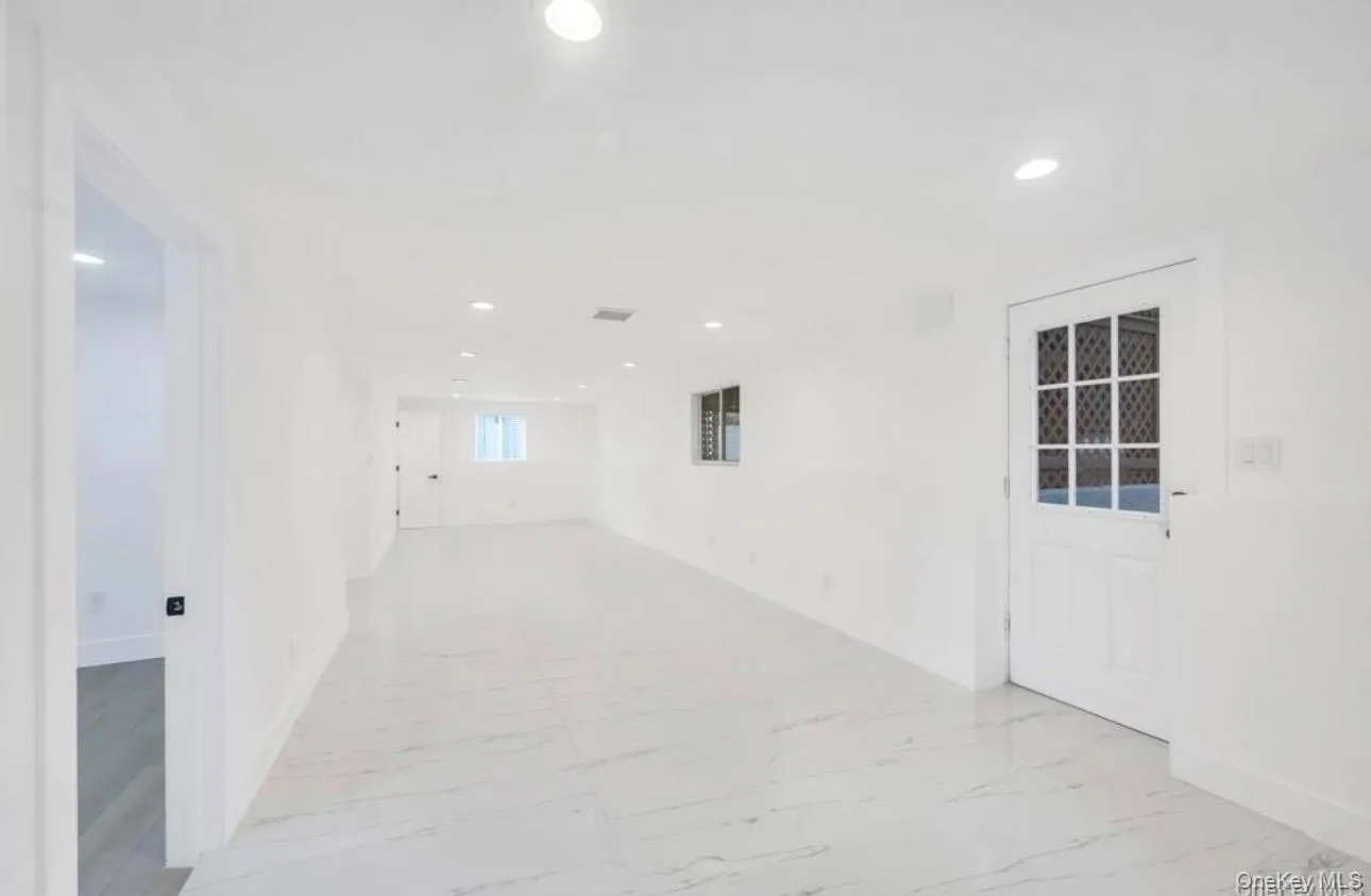 Unfurnished room with light marble finish floors and recessed lighting Unfurnished room with light marble finish floors and recessed lighting