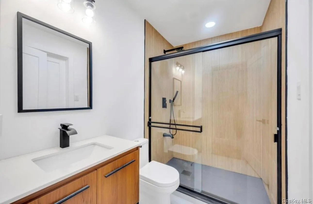 Bathroom featuring vanity, a shower stall, and recessed lighting Bathroom featuring vanity, a shower stall, and recessed lighting