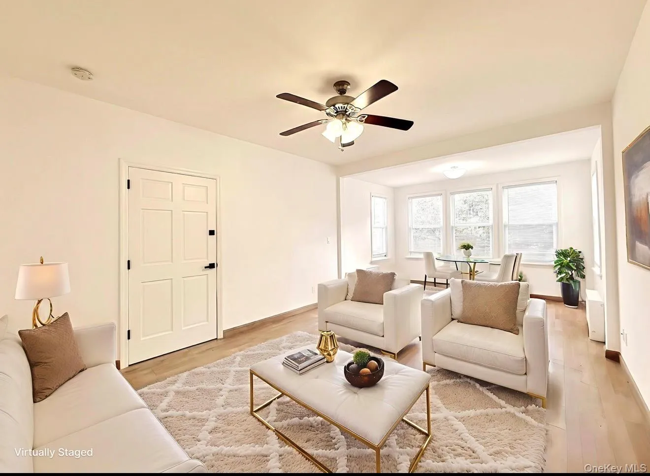 Living room featuring wood finished floors and ceiling fan Living room featuring wood finished floors and ceiling fan