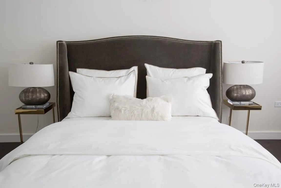 Bedroom featuring baseboards and wood finished floors Bedroom featuring baseboards and wood finished floors