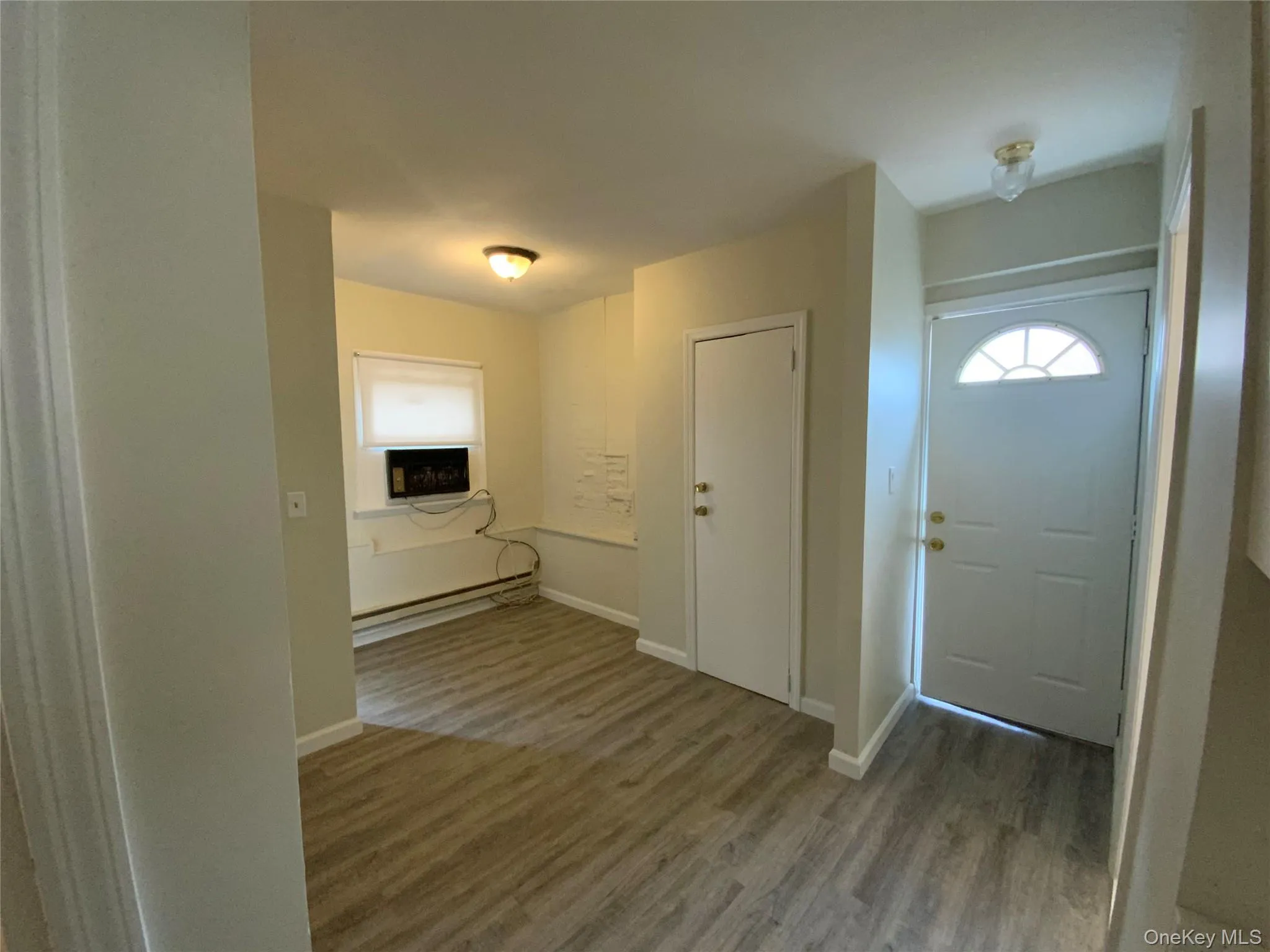 Entryway with wood finished floors and baseboard heating Entryway with wood finished floors and baseboard heating