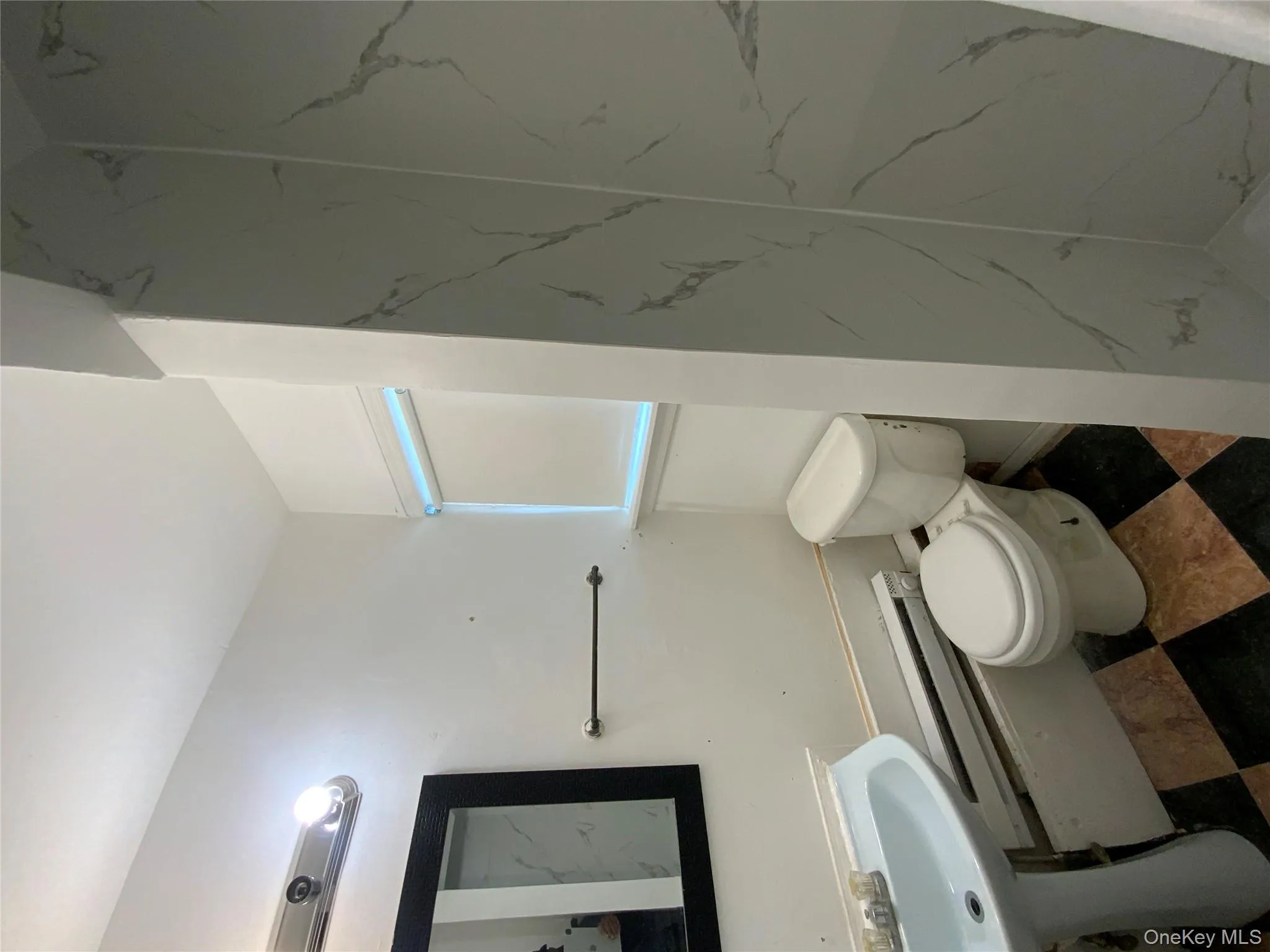 Full bathroom with a baseboard radiator and a marble finish shower Full bathroom with a baseboard radiator and a marble finish shower