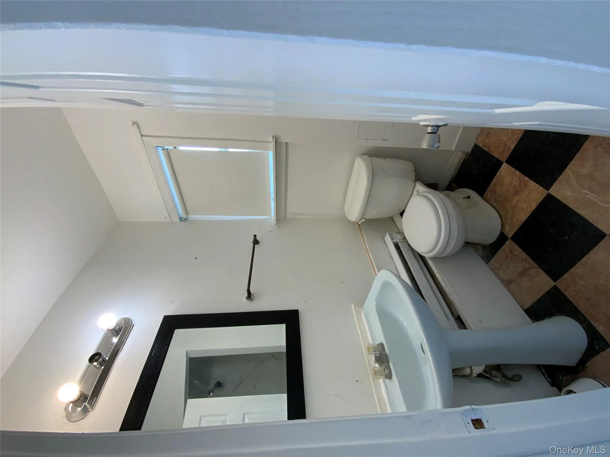 Bathroom with toilet and dark floors Bathroom with toilet and dark floors