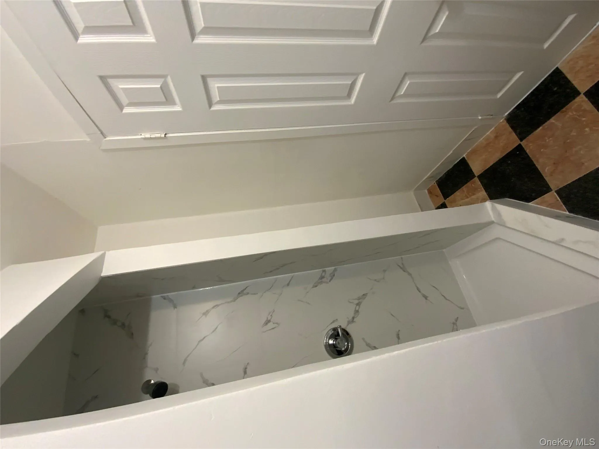 Bathroom featuring a marble finish shower and baseboards Bathroom featuring a marble finish shower and baseboards