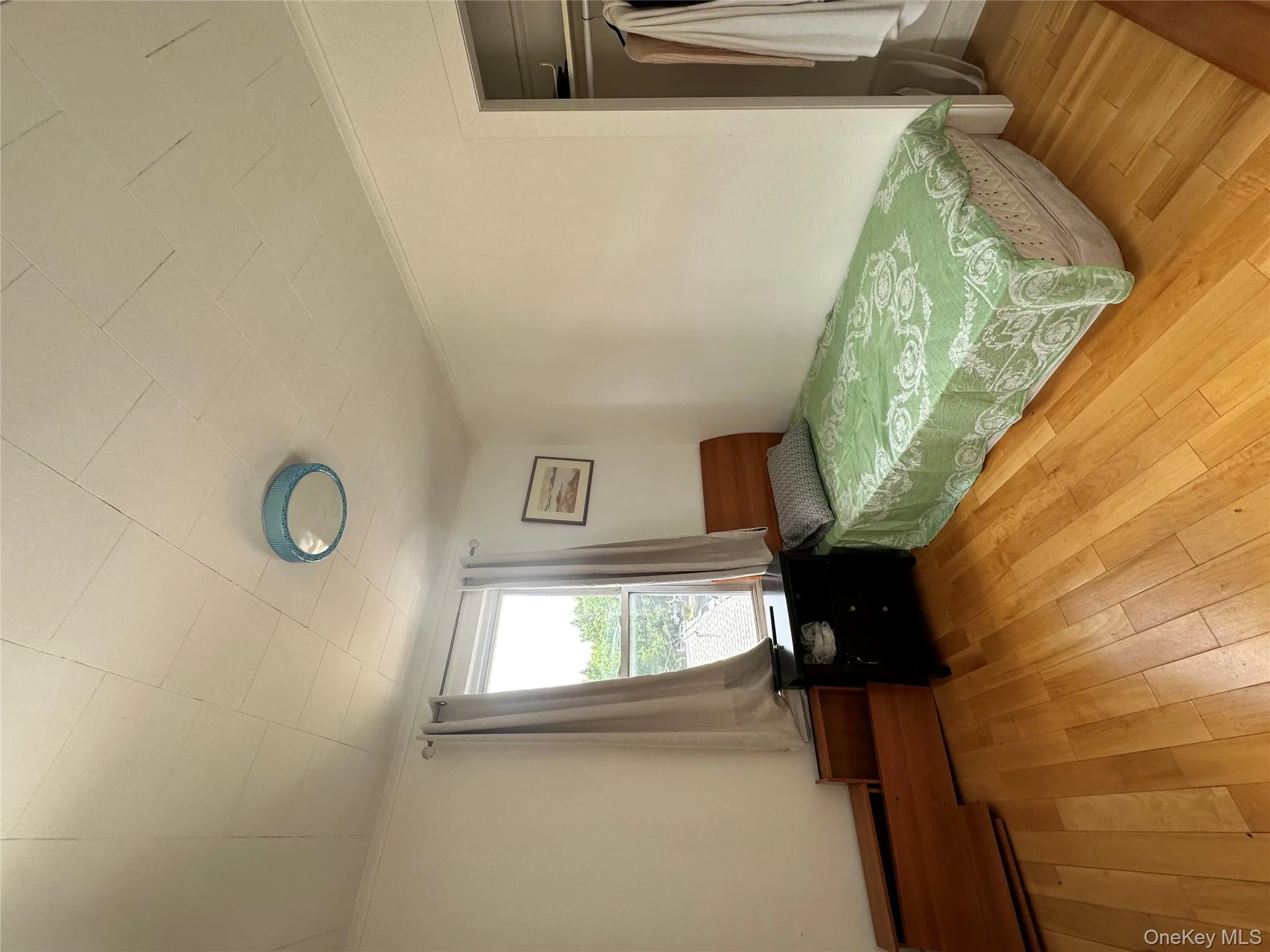 Bedroom featuring ornamental molding, hardwood / wood-style floors, and a closet Bedroom featuring ornamental molding, hardwood / wood-style floors, and a closet