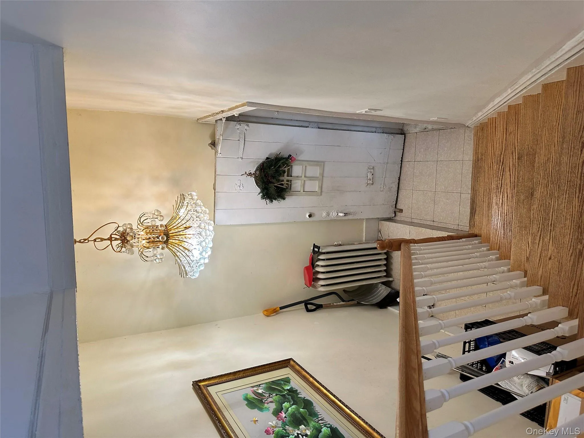 Stairs with a chandelier, wood finished floors, and radiator Stairs with a chandelier, wood finished floors, and radiator