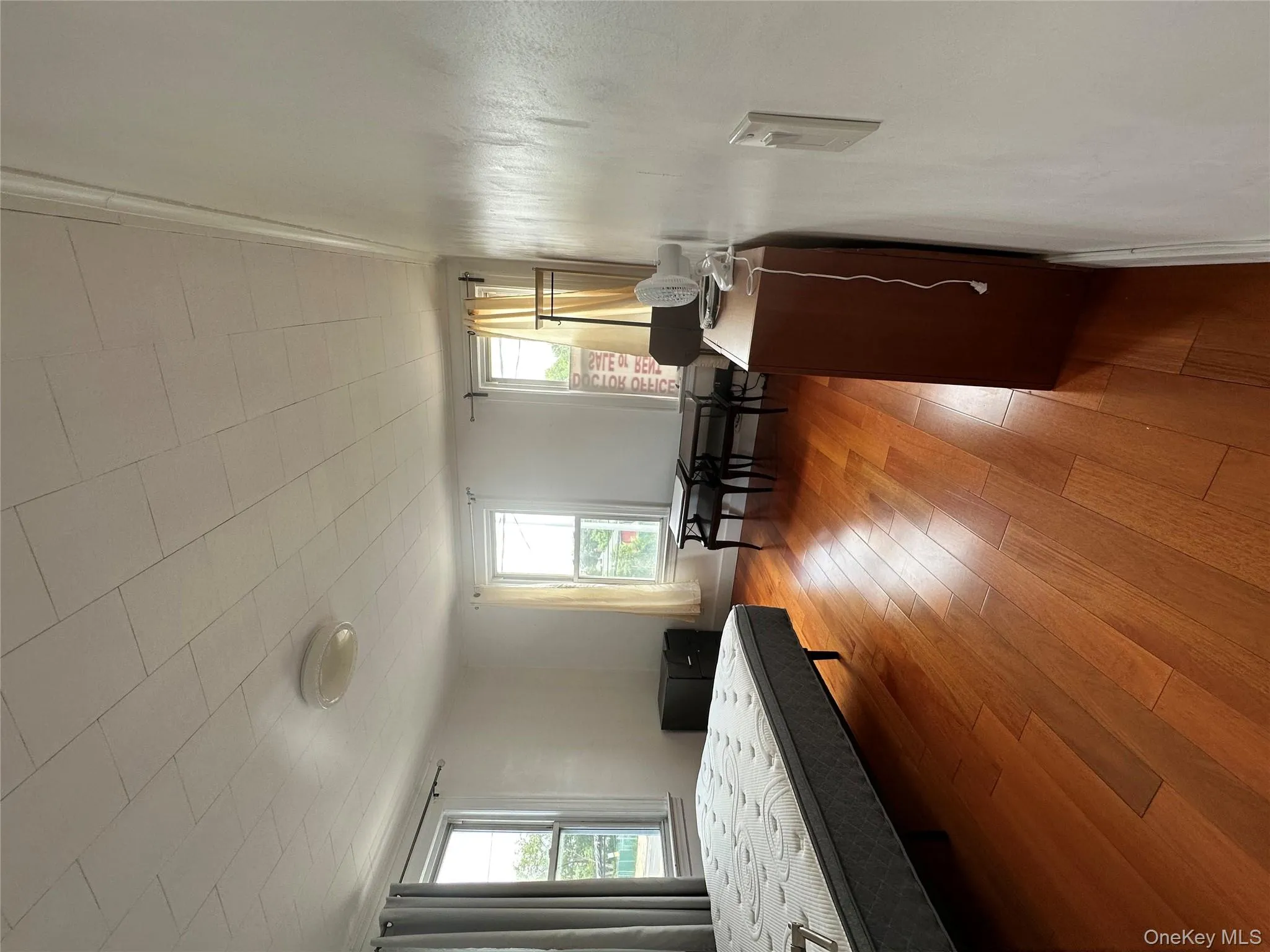 Bedroom with hardwood / wood-style flooring and baseboards Bedroom with hardwood / wood-style flooring and baseboards