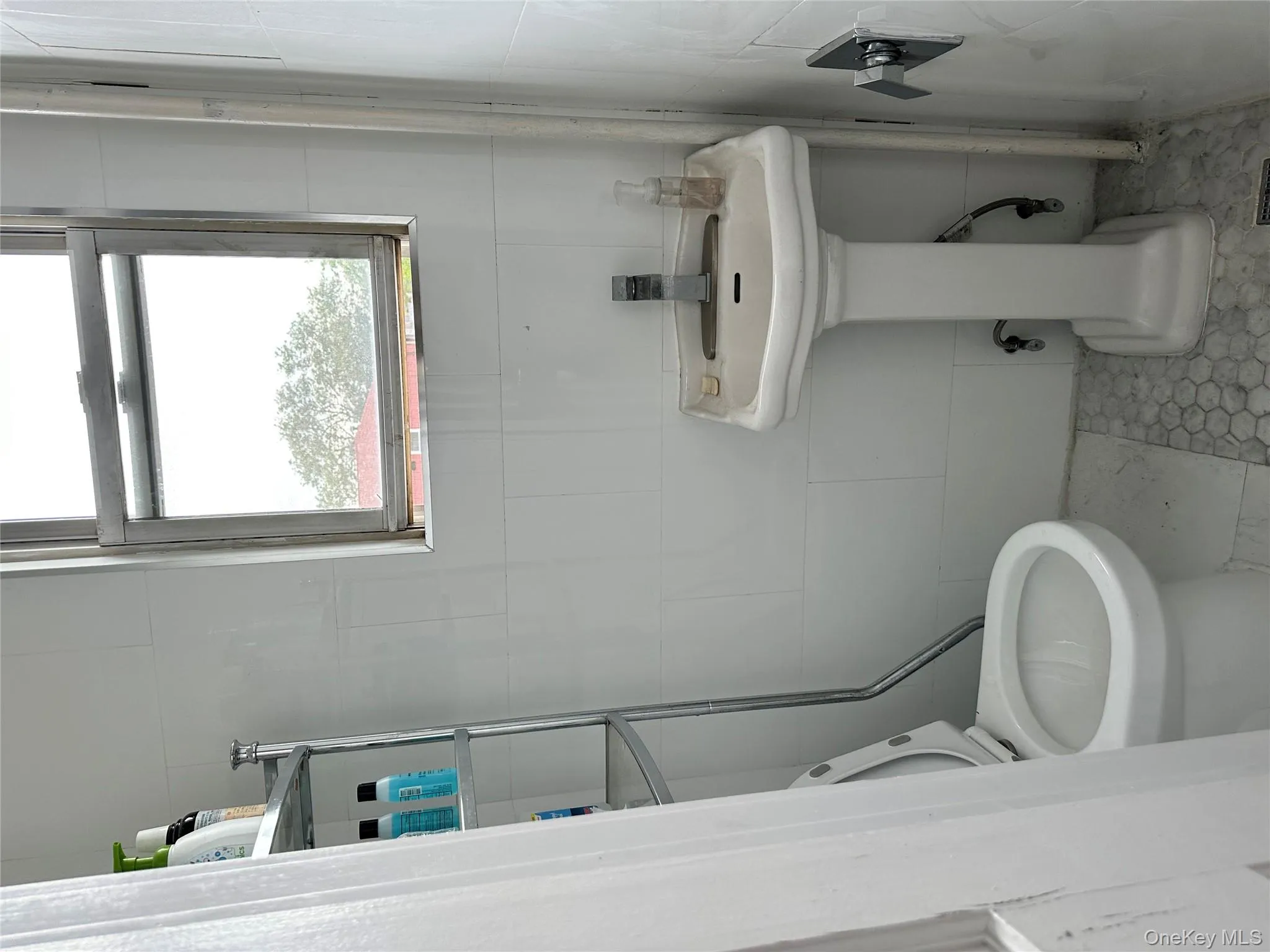 Half bathroom featuring tile walls and tile patterned floors Half bathroom featuring tile walls and tile patterned floors