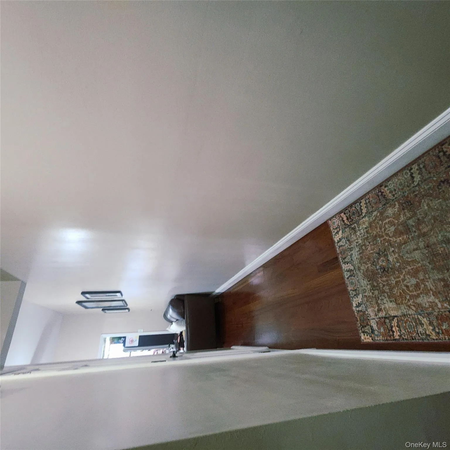 Hall with dark wood-style floors and baseboards Hall with dark wood-style floors and baseboards