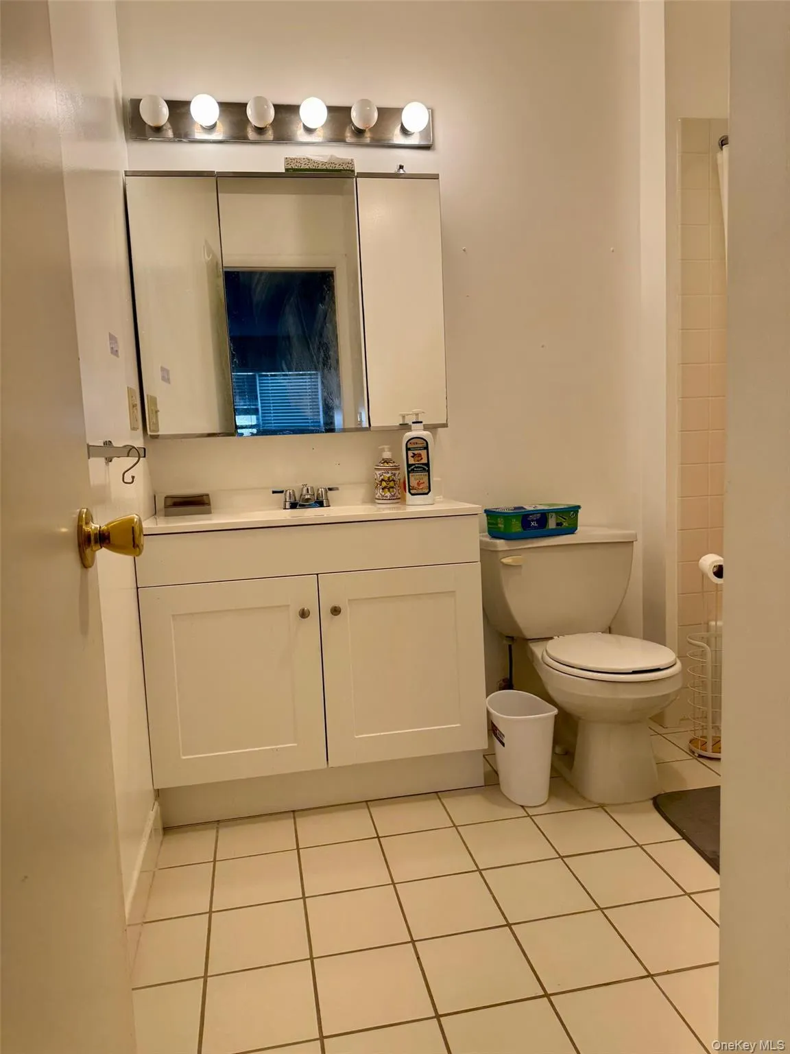 Bathroom with light tile patterned floors, vanity, and a shower Bathroom with light tile patterned floors, vanity, and a shower