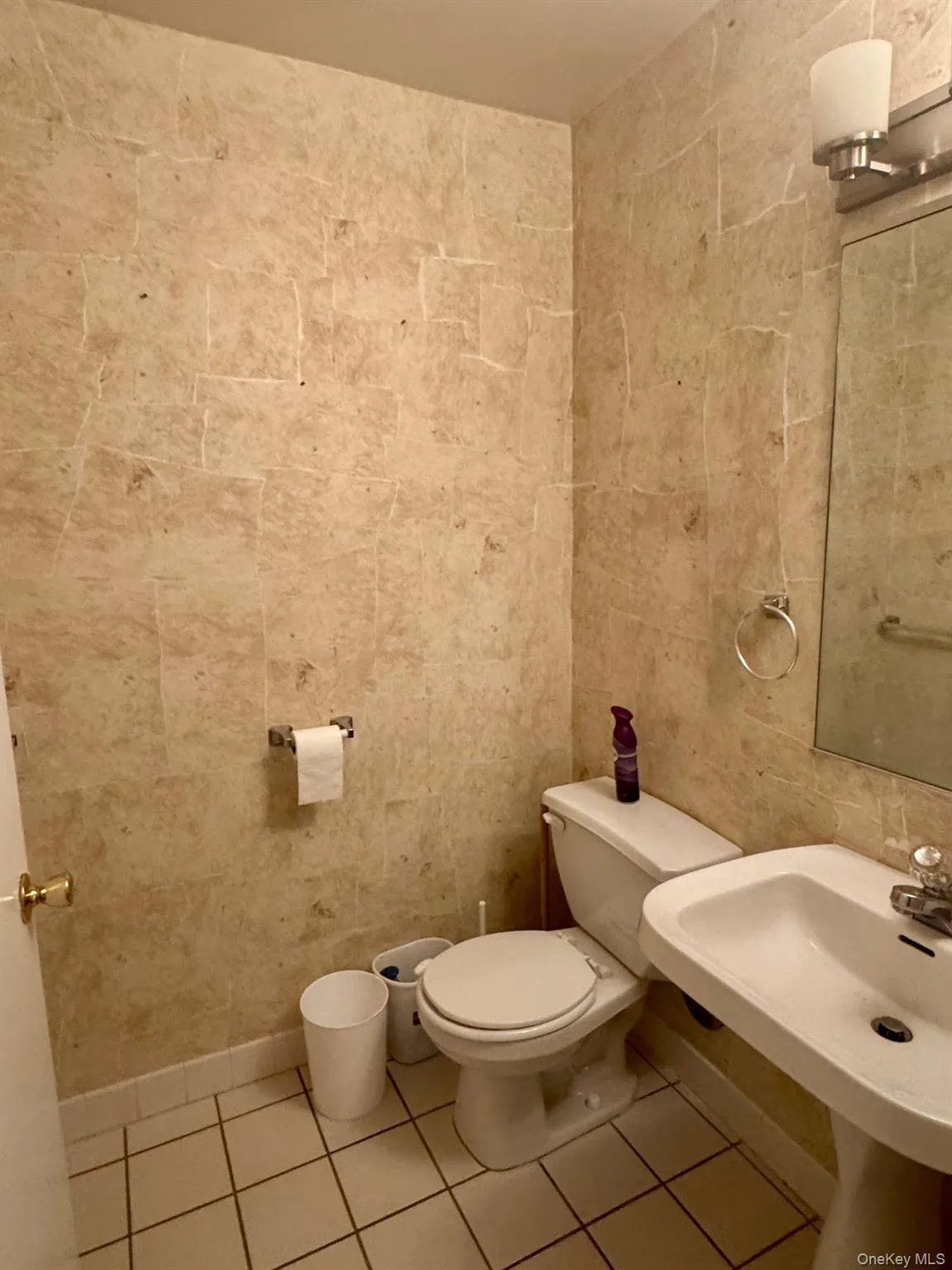 Half bathroom featuring tile patterned floors and toilet Half bathroom featuring tile patterned floors and toilet
