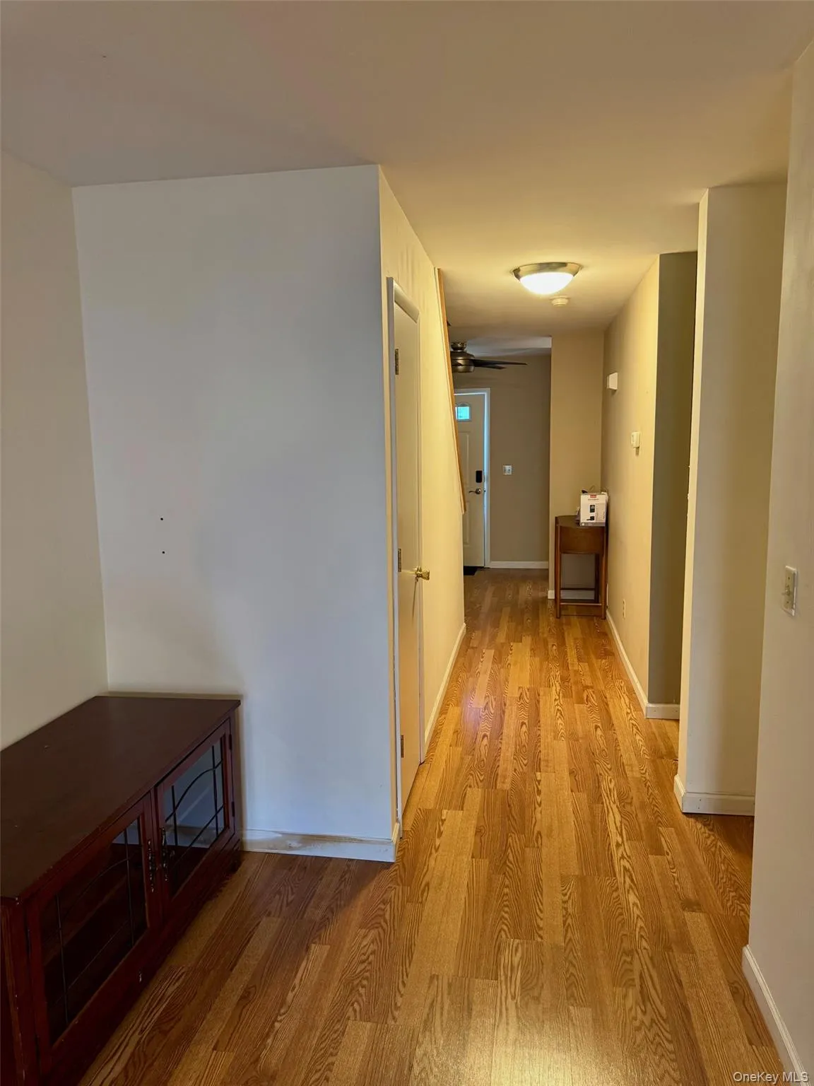 Hall with light wood-style flooring and baseboards Hall with light wood-style flooring and baseboards