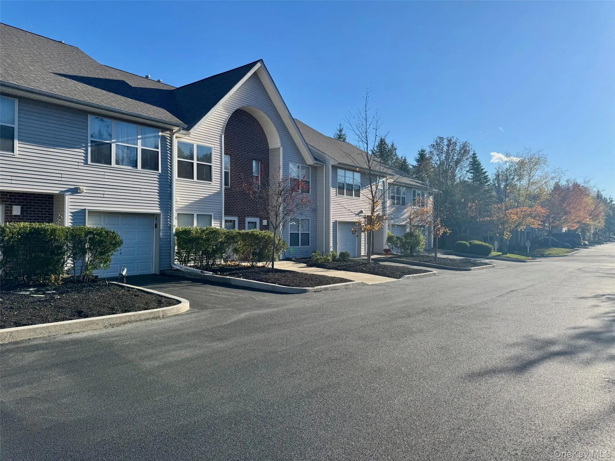 View of front of home with an attached garage, driveway, and a residential view View of front of home with an attached garage, driveway, and a residential view