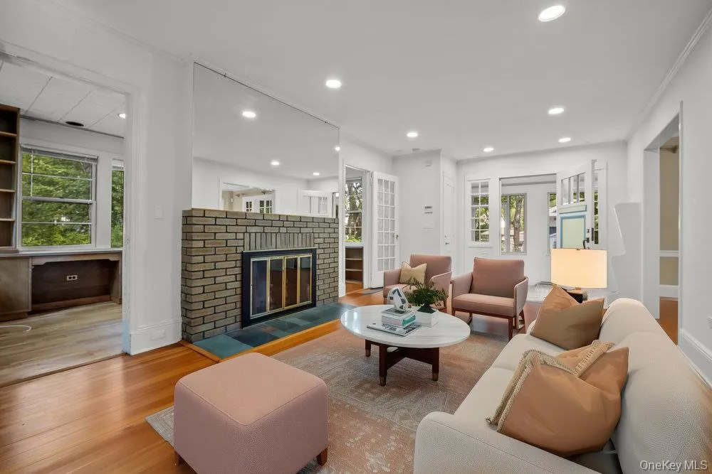 Living area featuring wood finished floors, a fireplace, and recessed lighting Living area featuring wood finished floors, a fireplace, and recessed lighting