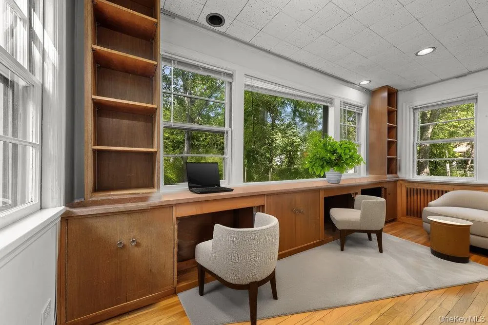 Office space featuring built in study area and light wood-style flooring Office space featuring built in study area and light wood-style flooring