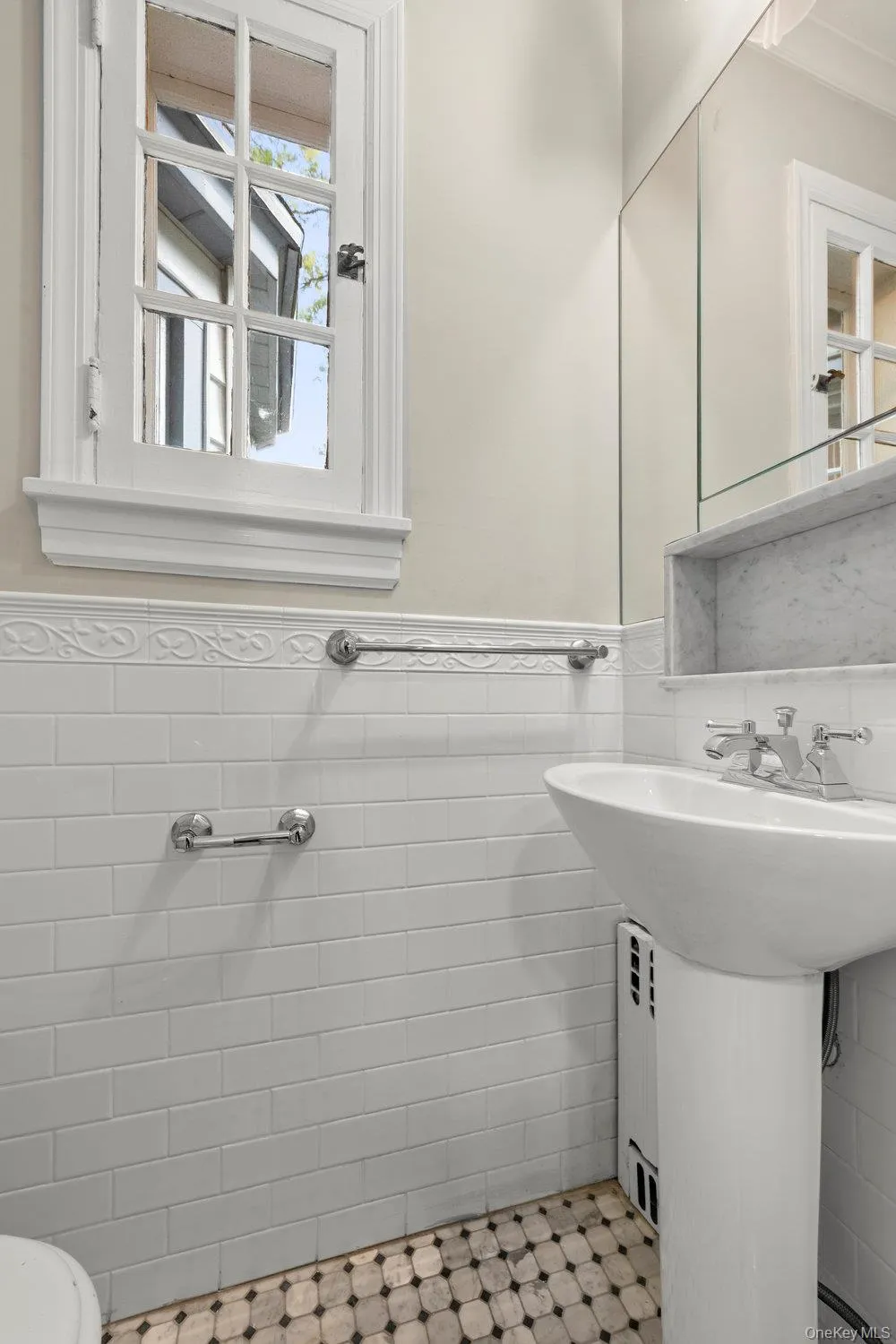 Half bath featuring tile walls and a wainscoted wall Half bath featuring tile walls and a wainscoted wall