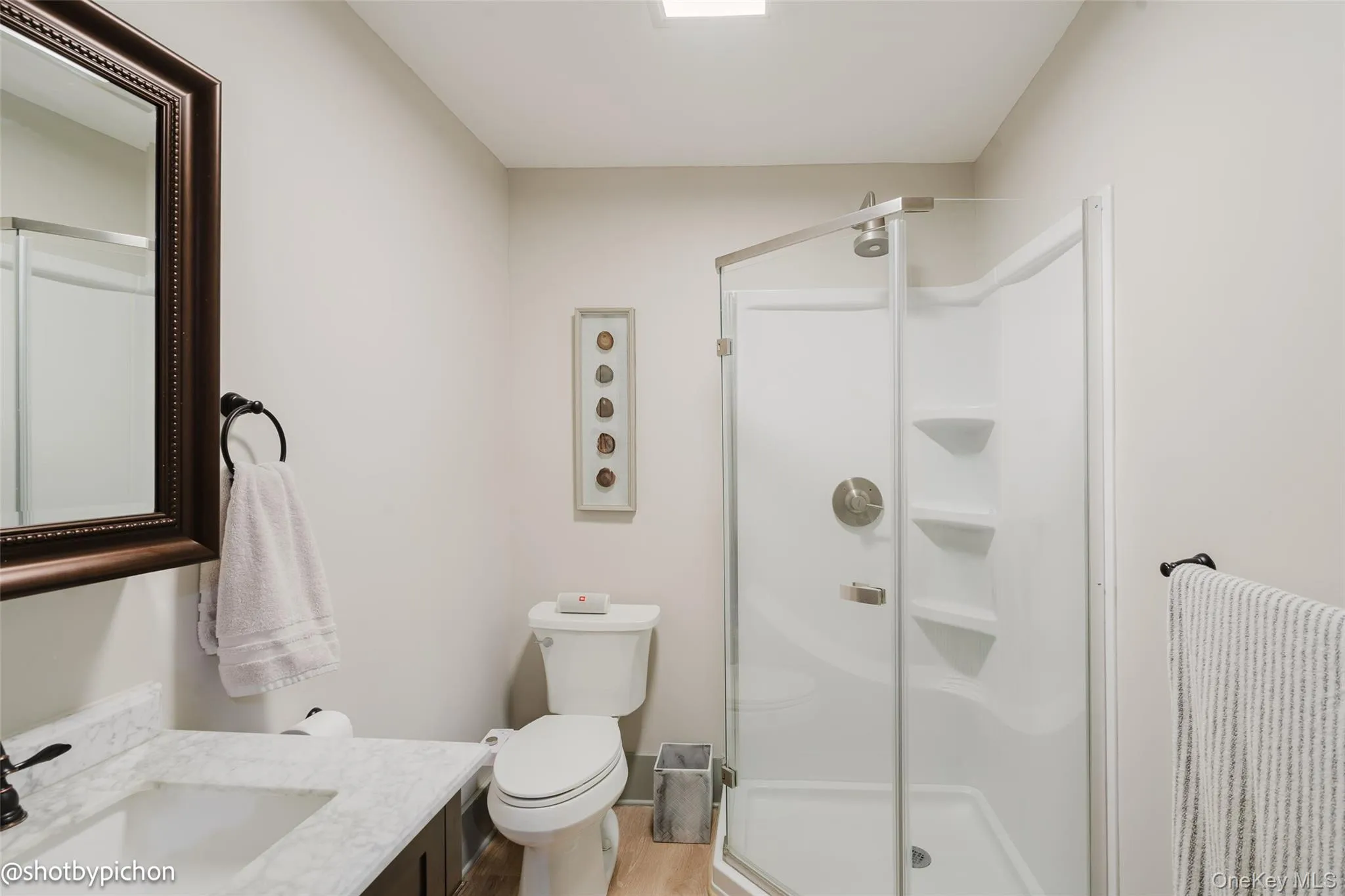 2nd Bathroom featuring vanity, a stall shower, and light wood-type flooring 2nd Bathroom featuring vanity, a stall shower, and light wood-type flooring