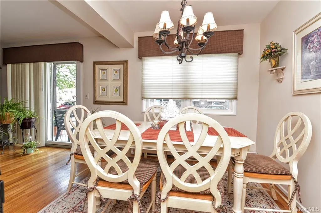 Dining space featuring a chandelier and wood finished floors Dining space featuring a chandelier and wood finished floors