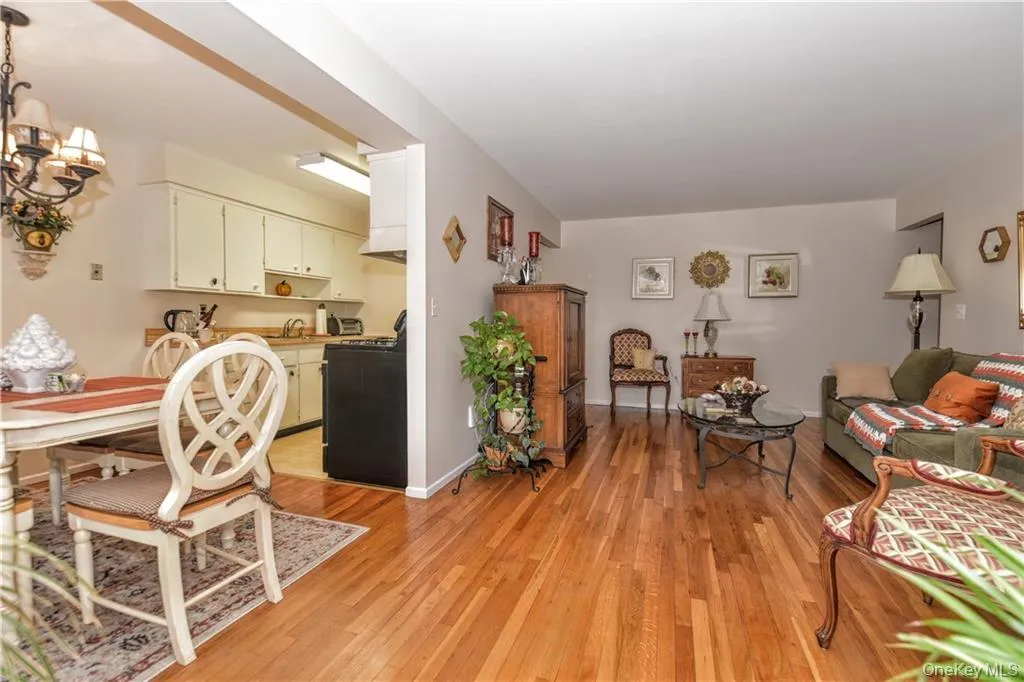 Living room with light wood-style floors and a chandelier Living room with light wood-style floors and a chandelier