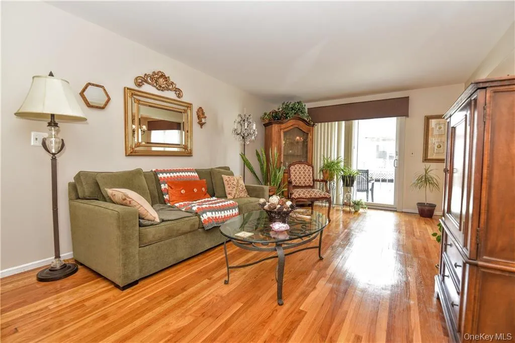 Living area featuring baseboards and light wood-style floors Living area featuring baseboards and light wood-style floors
