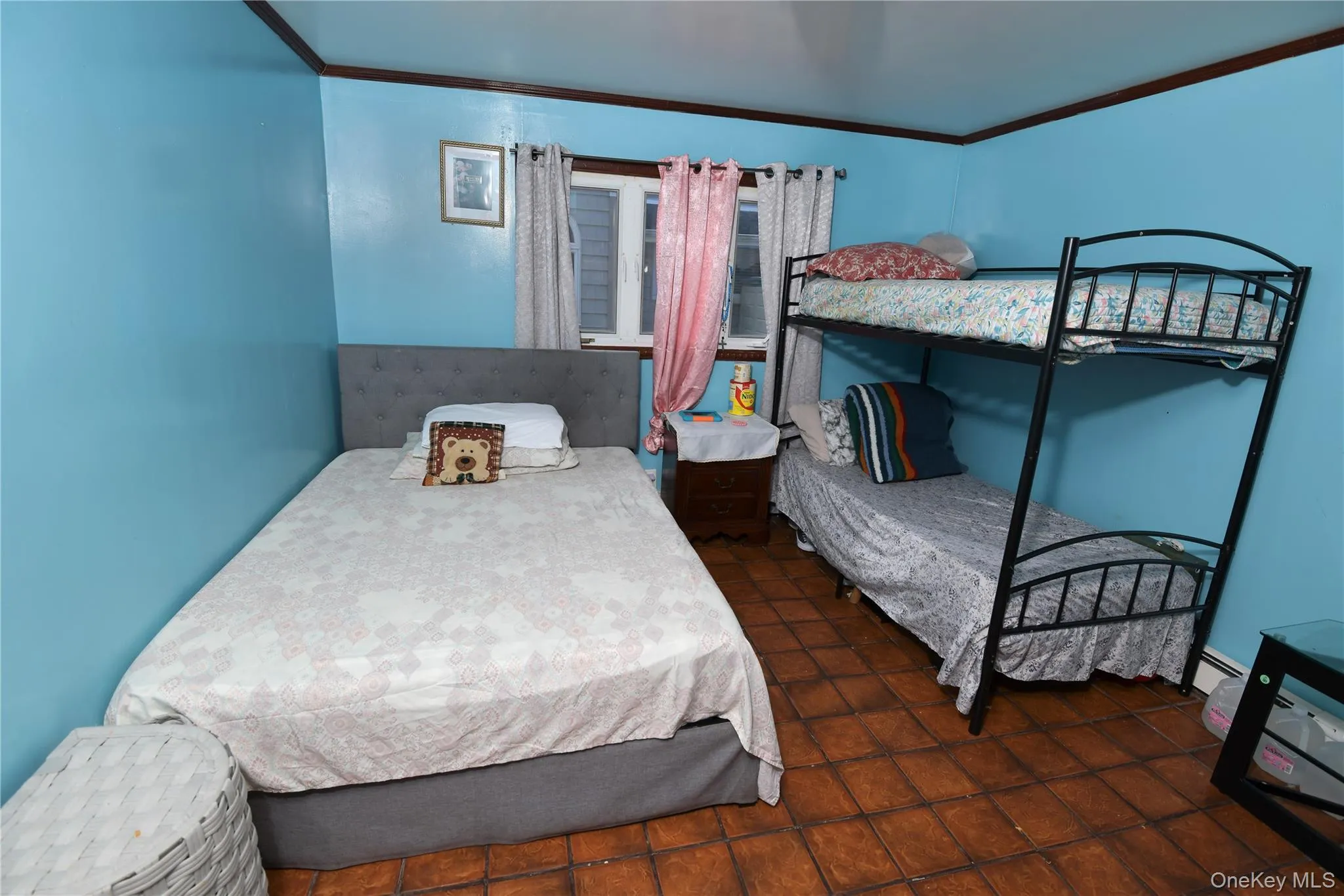 Bedroom with crown molding and dark tile patterned floors Bedroom with crown molding and dark tile patterned floors
