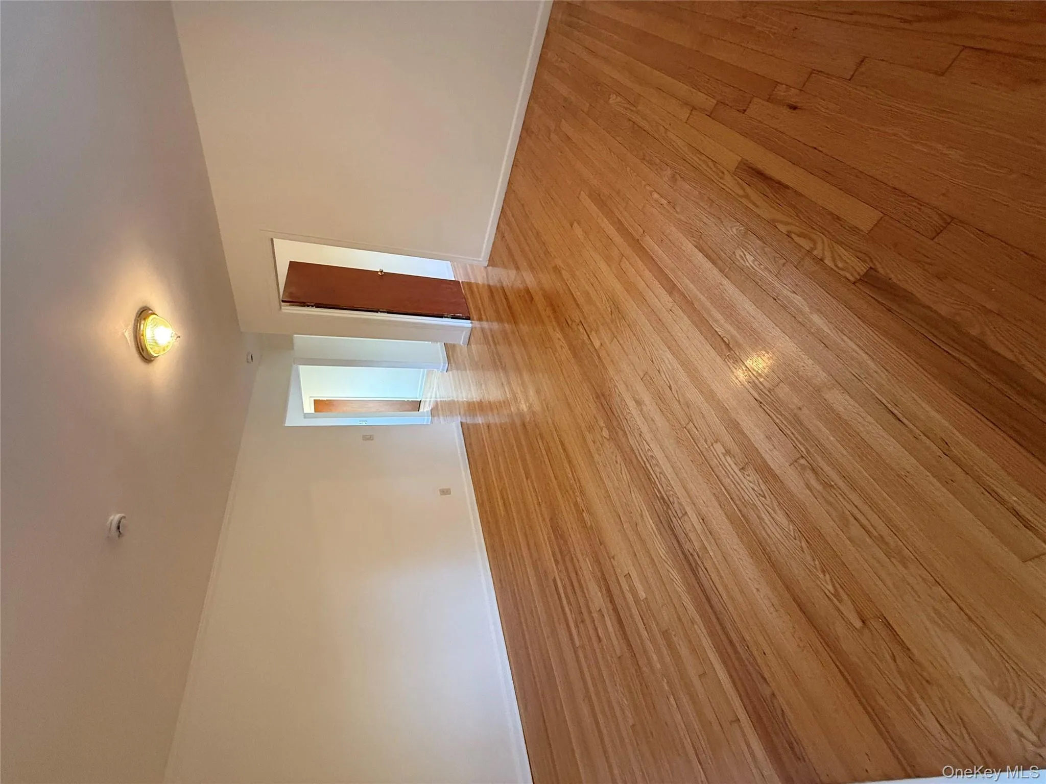 Unfurnished room featuring light wood finished floors and baseboards Unfurnished room featuring light wood finished floors and baseboards