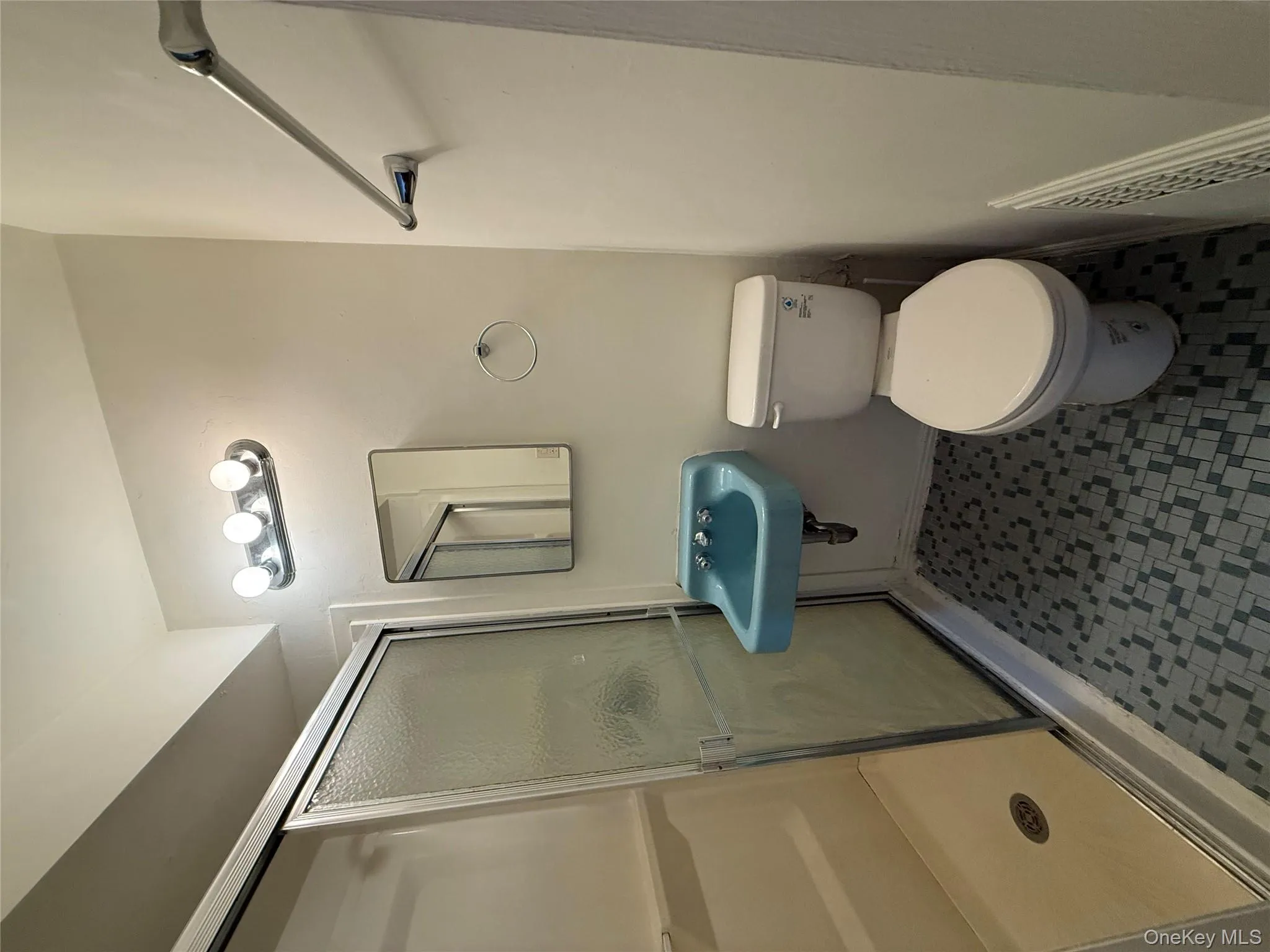 Bathroom featuring a shower stall and toilet Bathroom featuring a shower stall and toilet